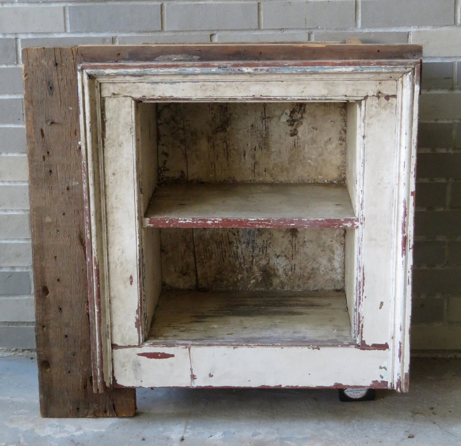 A primitive built-in wall cupboard with picture frame: A primitive built-in wall cupboard with picture frame molding and open front (never had a door). Early to mid 19th century. Good condition. 29 3/4"W x 14 1/2"D x 30 1/2"H.