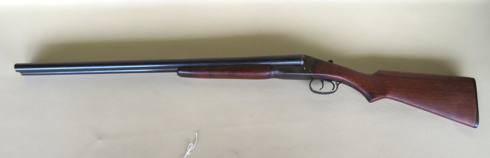 Stevens Savage, Model 311A, double barrel 12 ga.: Stevens Savage, Model 311A, double barrel 12 ga. Shotgun. Walnut stock. Slight surface rust spots and scratches, good bluing, the black painted finger guard with use wear to paint, small loss to top o