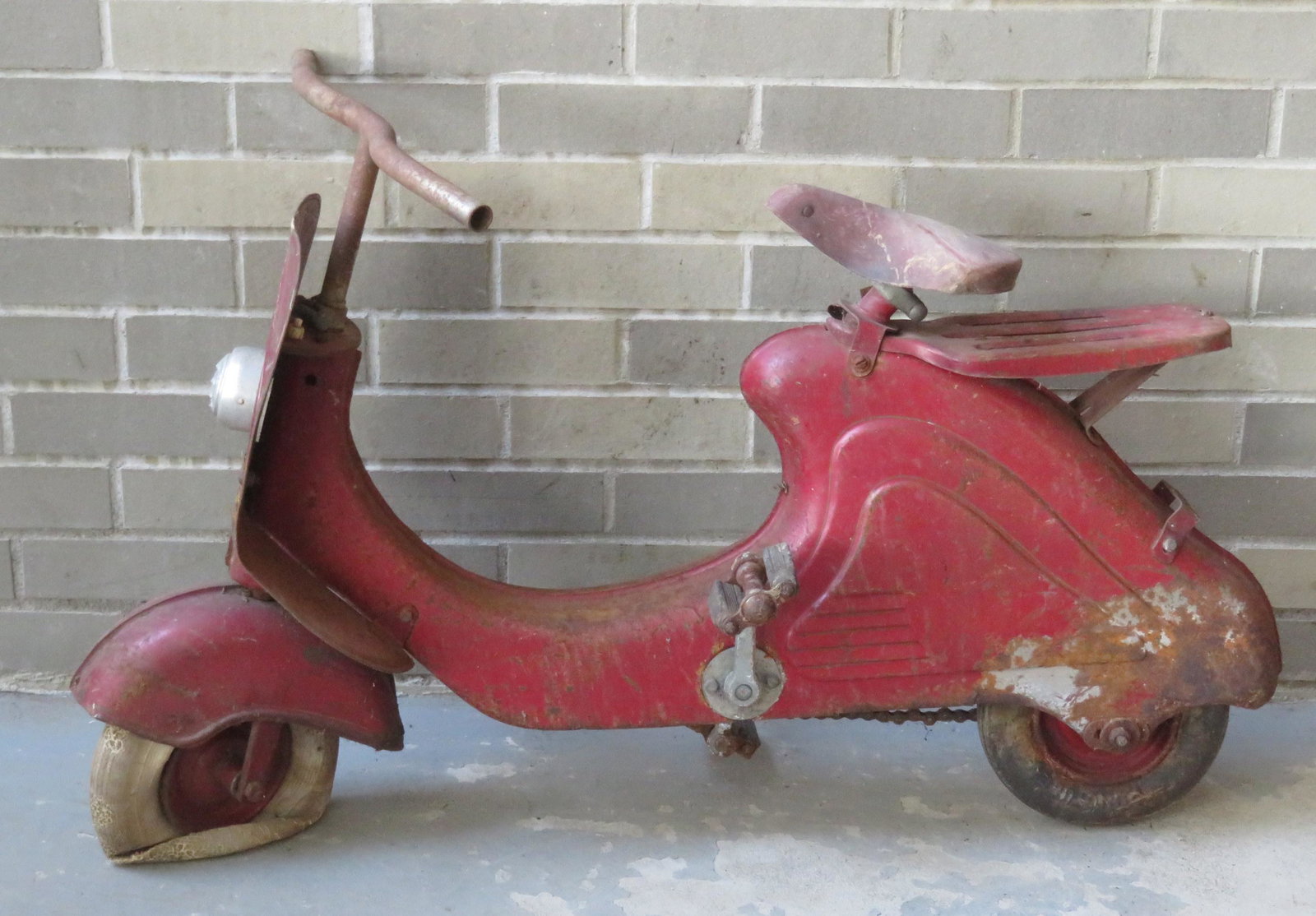 German 1950's Marjet pedal scooter in original paint.: German 1950's Marjet pedal scooter in original paint. Front tire is flat and needs replacement - barn found with extensive rusting (most appears to be surface rusting and no holes), otherwise fair con