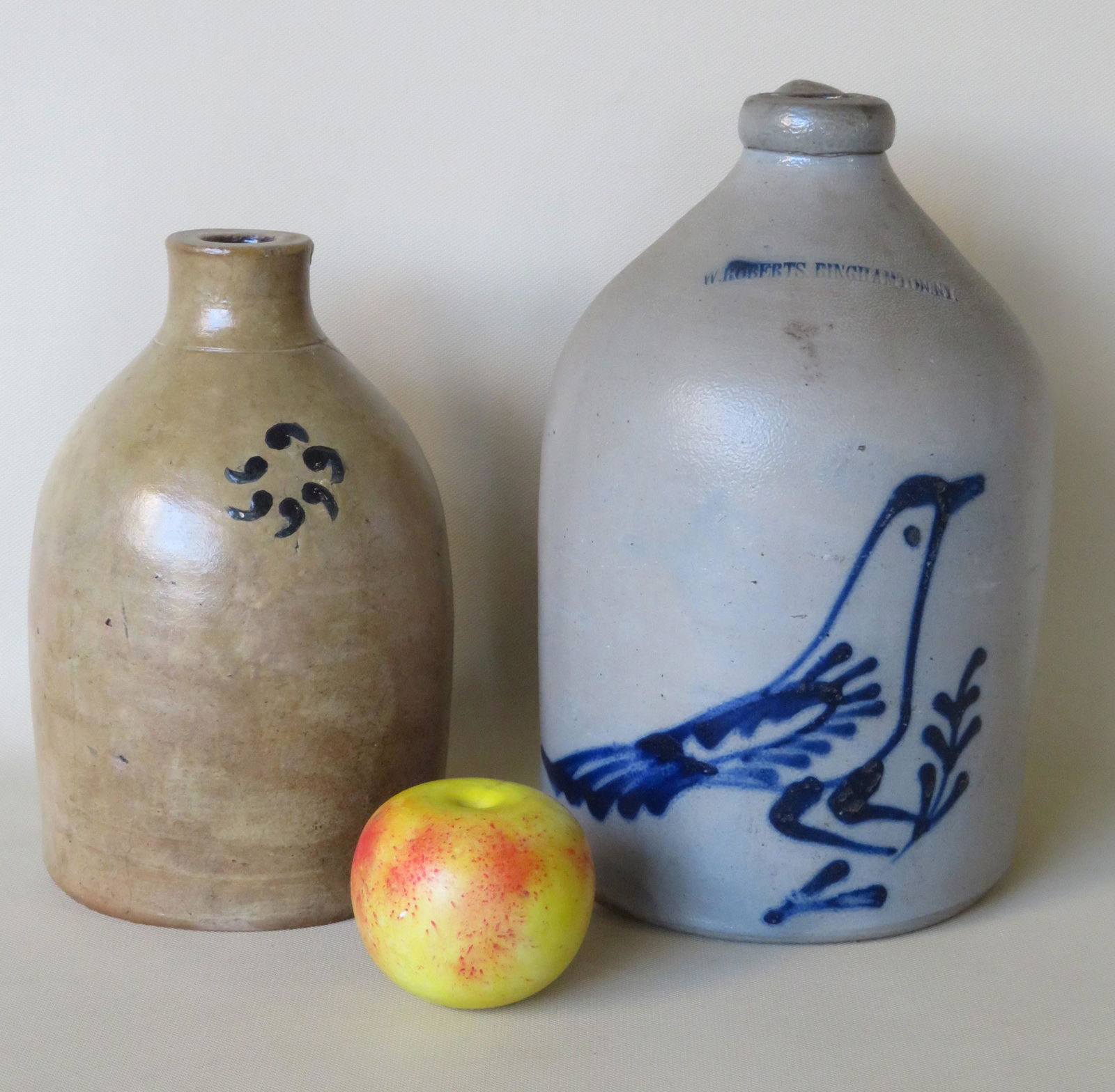 Two small stoneware jugs including: The first with: Two small stoneware jugs including: The first with impressed mark of "W. Roberts. Binghamton. N.Y.", and decorated with a large deep cobalt blue bird on branch, probably 1 gallon or less - minor stain