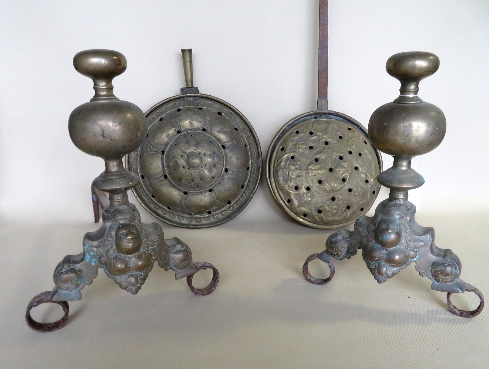 Three 17th/18th century Dutch hearth items including a: Three 17th/18th century Dutch hearth items including a pair of figural brass andirons having a bulbous standard over a base depicting a queen with stepped legs leading to circular hand forged iron fee