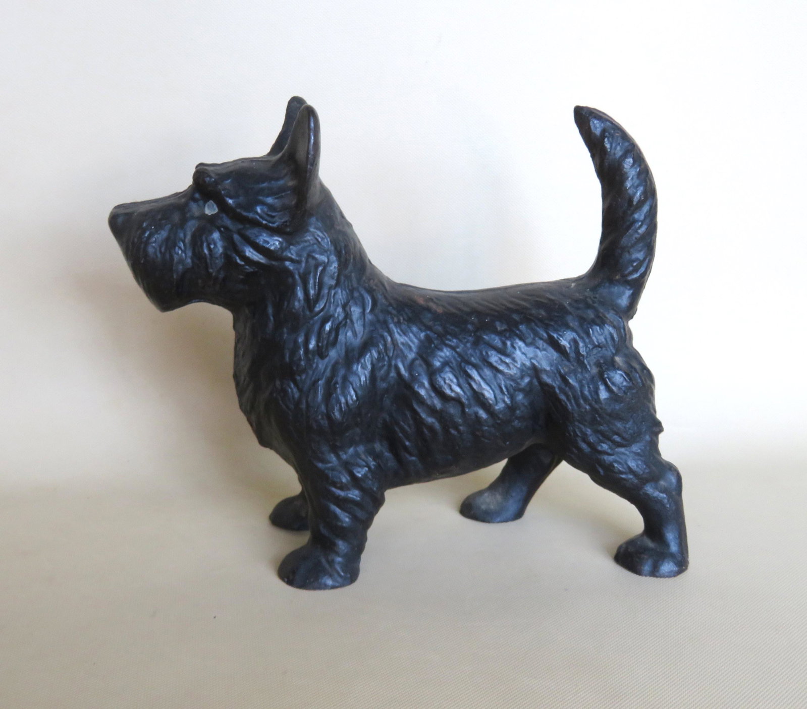 Cast iron Scottie dog door stop in old black paint,: Cast iron Scottie dog door stop in old black paint, very good condition. 10"W x 9"H. Circa 1900.