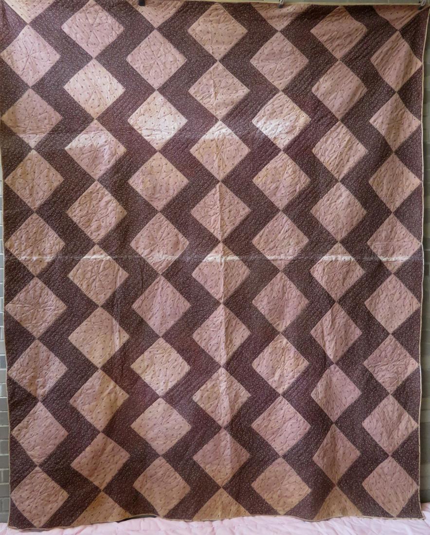 Patchwork quilt, possibly Amish, Zigzag pattern with: Patchwork quilt, possibly Amish, Zigzag pattern with interspersed quilted flowers, all hand sewn, 19th century. Fading along center fold line, and 4 other patches with some fading (see photos), but ov