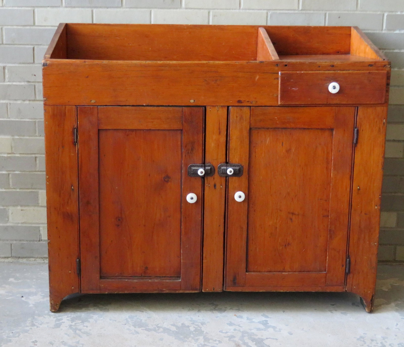 Pine dry sink having an open well adjacent to a single: Pine dry sink having an open well adjacent to a single drawer and over 2 doors - appears to retain original hardware - 19th century - very good condition. 41 1/4"W x 18"D x 36"H.