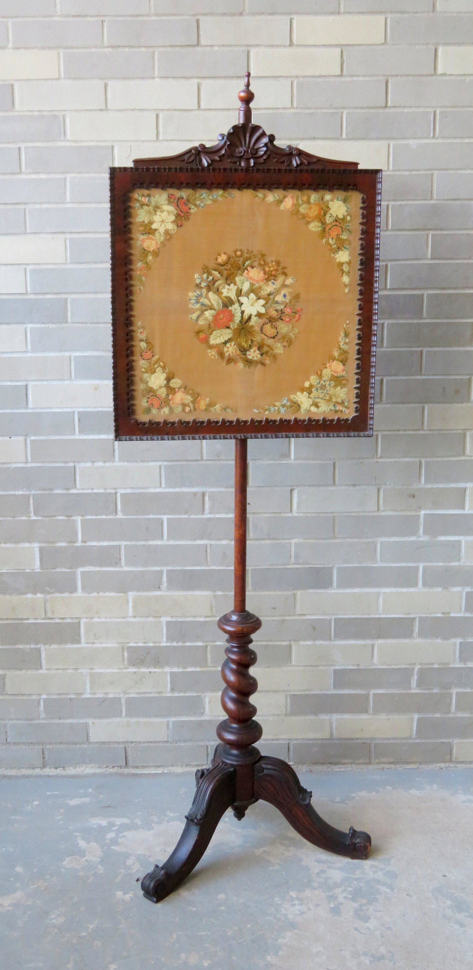 The best fire pole screen having a gothic shield shaped: The best fire pole screen having a gothic shield shaped mahogany frame surrounding a textile of petit point flowers on linen, mounted on an adjustable wooden pole leading to a faux rosewood grain pain