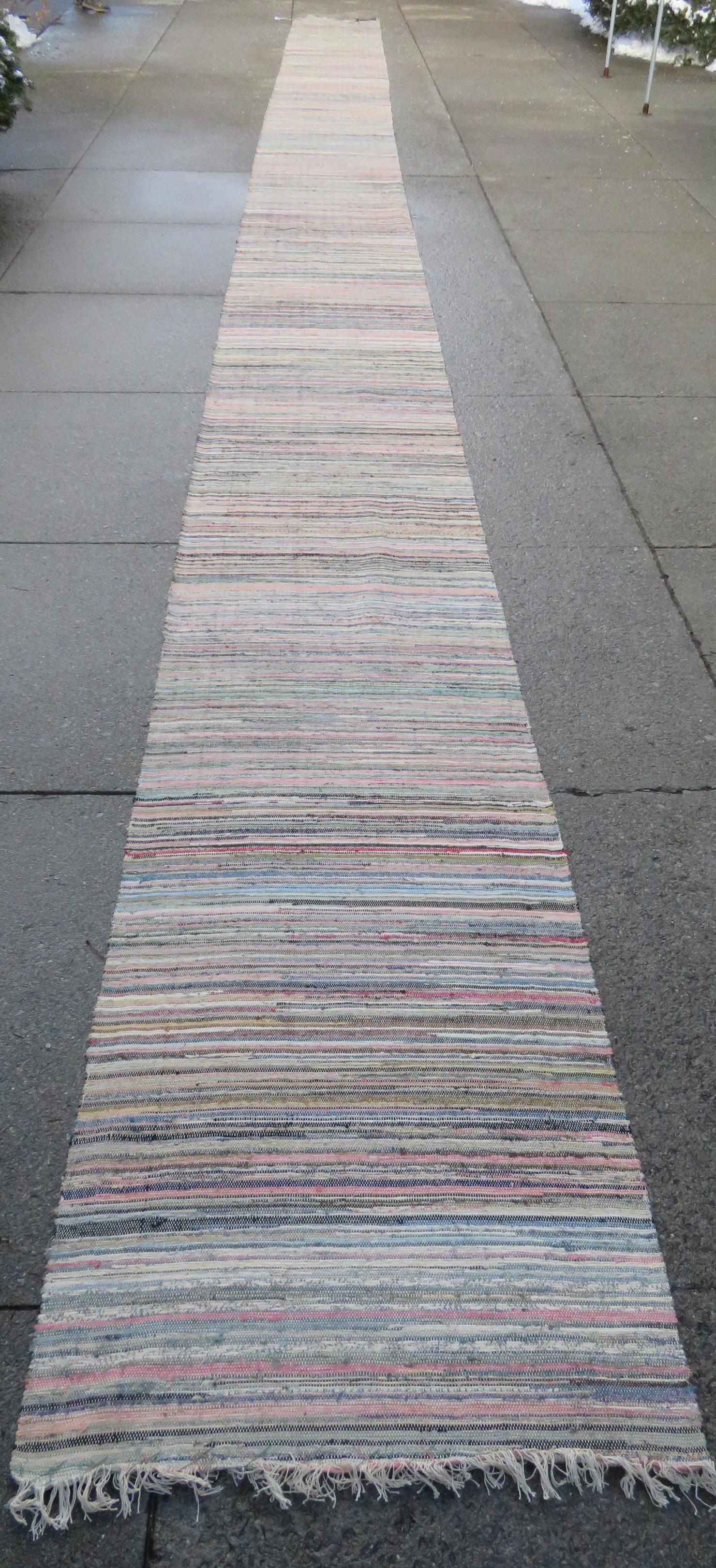 Long rag rug runner, probably late 19th century. Slight: Long rag rug runner, probably late 19th century. Slight fraying on one end, otherwise very good condition. Size 47' 10"L x 35 1/2"W.