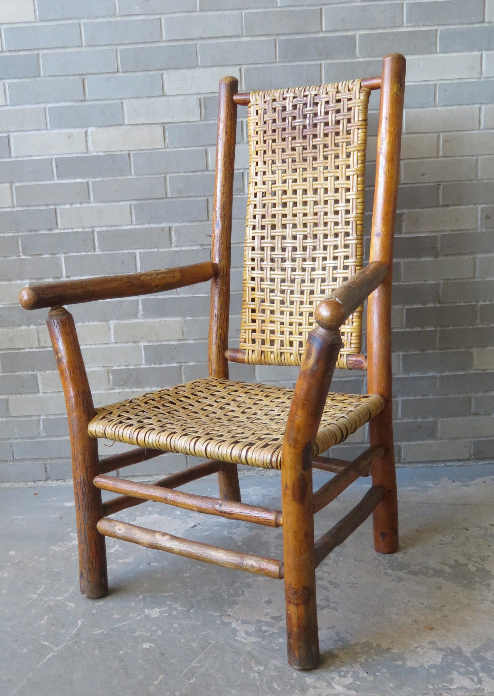 Vintage "Old Hickory" porch or lodge arm chair with: Vintage "Old Hickory" porch or lodge arm chair with original cane seat and back - very good condition - branded "Old Hickory / Martinsville Indiana". 44 1/2"H x 29 1/2"W x 20"D.