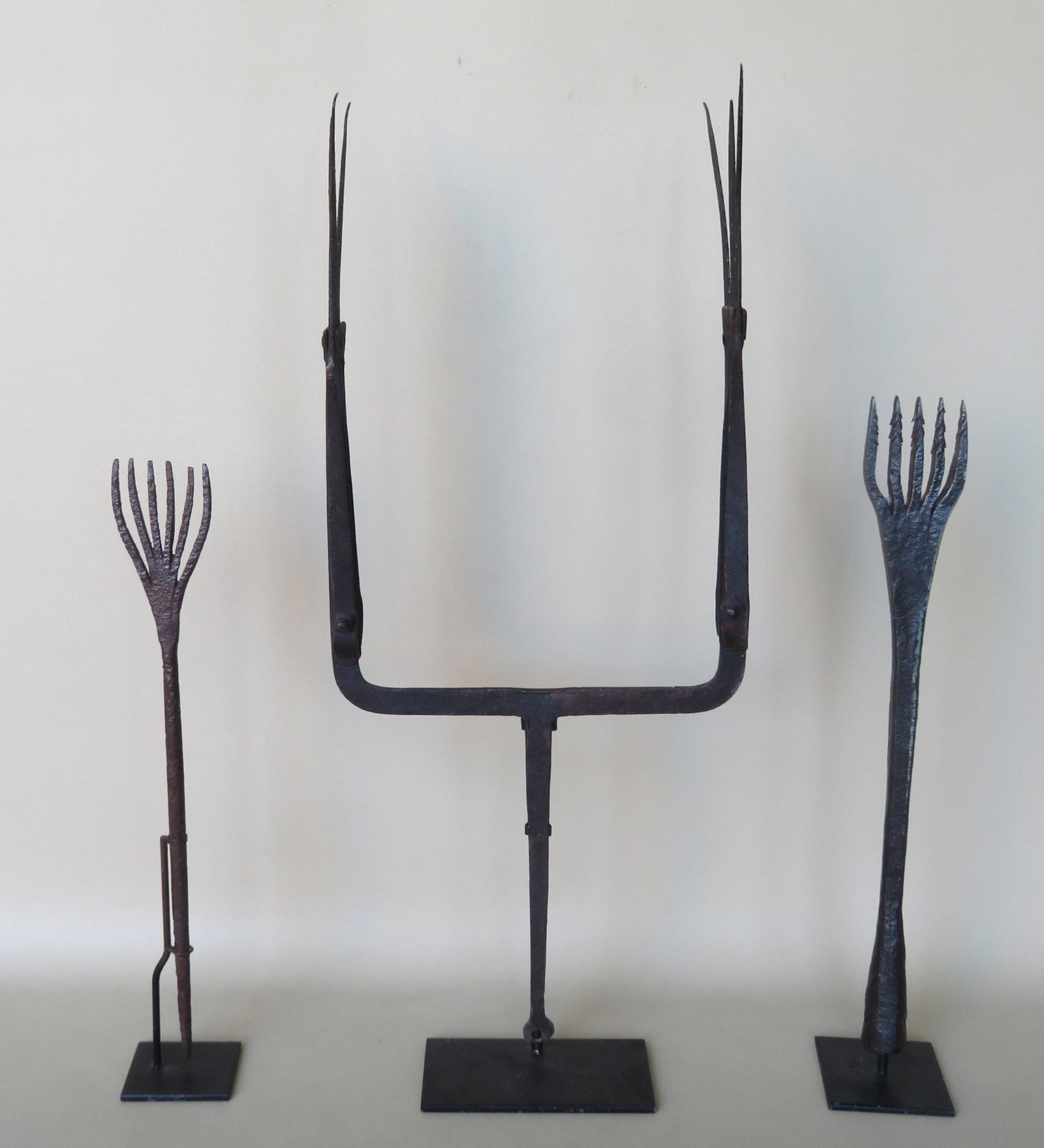 Thee hand forged iron eel spears, including a rare: Thee hand forged iron eel spears, including a rare double spear. All 18th/19th century. Ranging in size from 16"H to 24"H. All in very good condition.