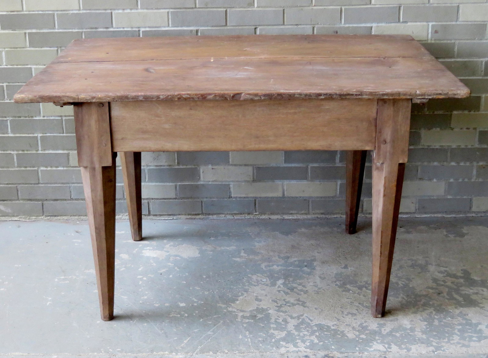 Early farm table having a 2 board ship-lapped top,: Early farm table having a 2 board ship-lapped top, cleat board ends, and octagonal shaped tapered legs, probably 18th century, old worn finish. 4' x 35 1/2". Some staining and use wear, but overall go
