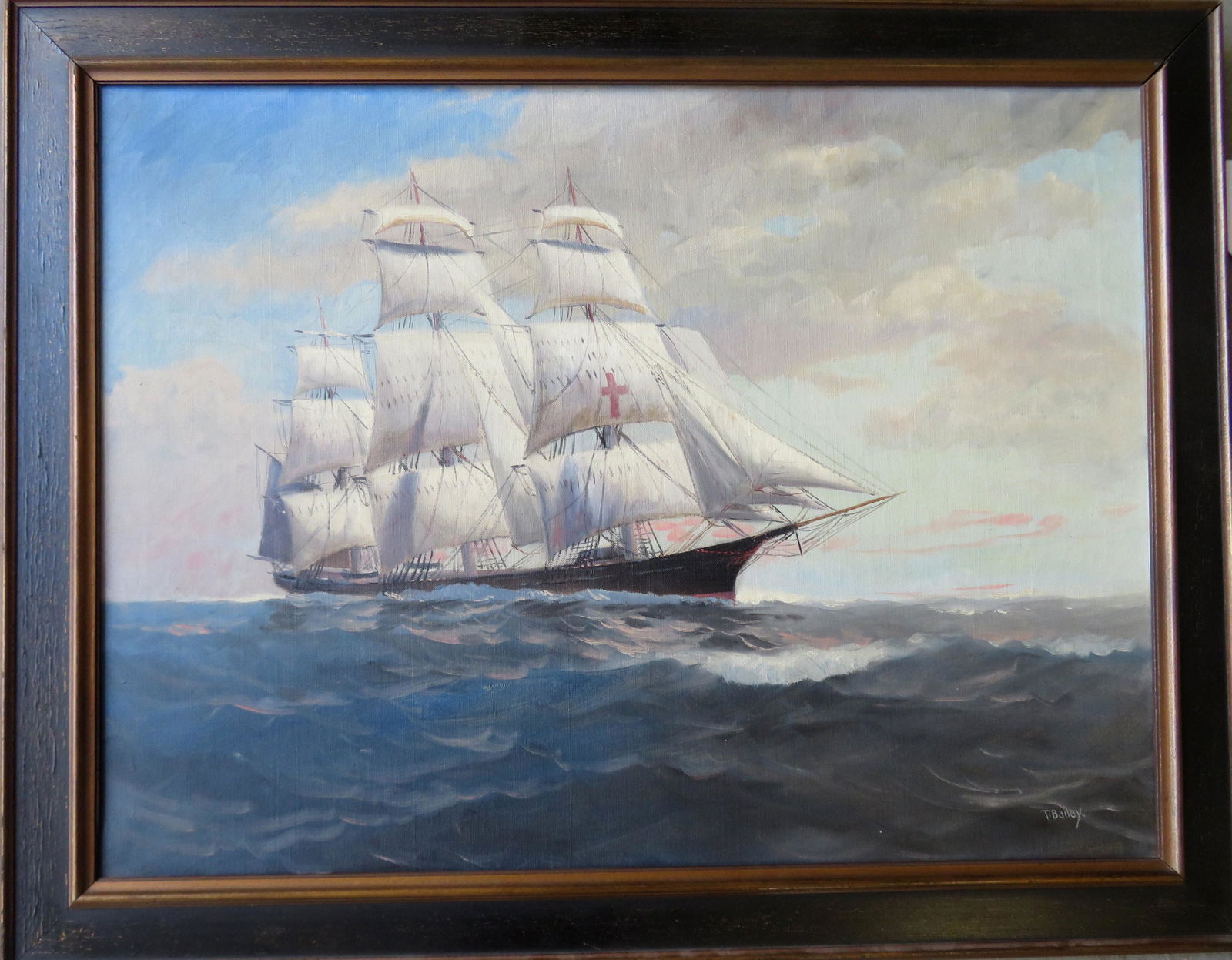 O/C Portrait of a fully rigged schooner, with red: O/C Portrait of a fully rigged schooner, with red cross painted on sail, signed T. Bailey, early 20th century. Stretcher is marked "Bay State Stretcher/ Boston Mass/".Two repairs noticeable on reverse