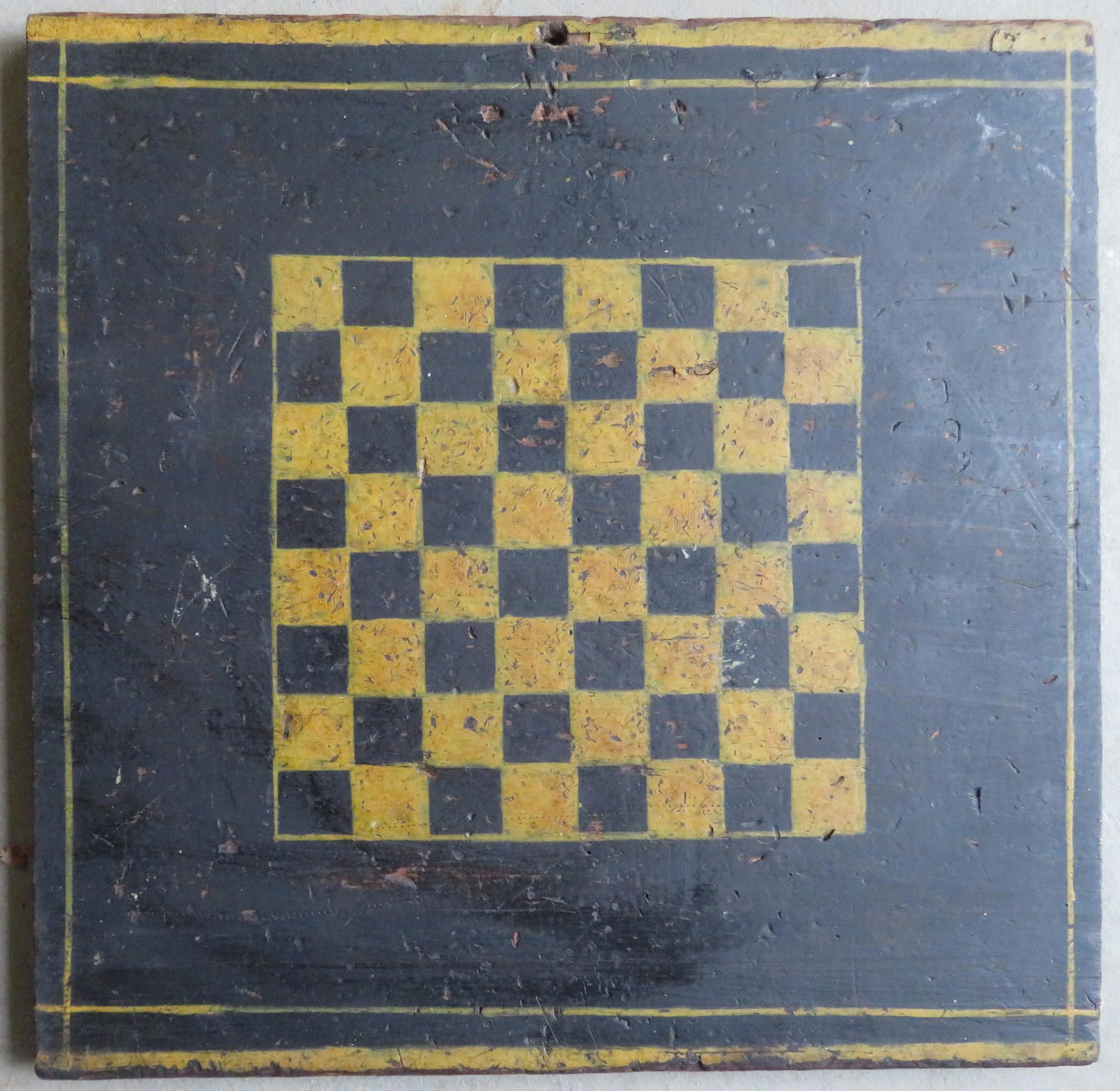 Early game board in original black and mustard paint: Early game board in original black and mustard paint and also having a double mustard pinstripe border, 19th century. The board likely had molding applied to 2 ends which is missing - the nails that w