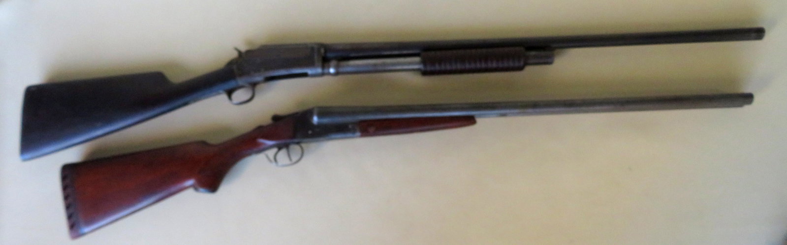 Two vintage shotguns including: Marlin Model 21, pump,: Two vintage shotguns including: Marlin Model 21, pump, 12 gauge, 1904, serial number 94280 - some surface rust, abrasions to stock, shotgun does not stay cocked - barrel length 29 1/4" - overall lengt