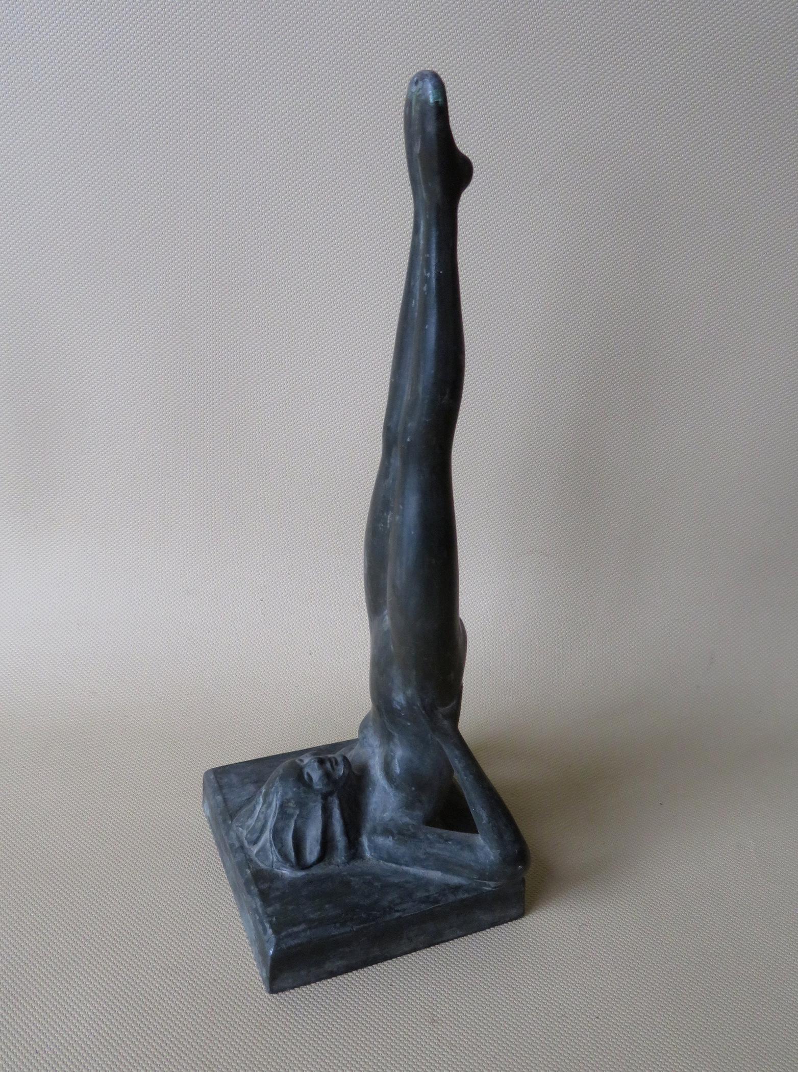 A signed Frankart sculpture of a nude lady stretching: A signed Frankart sculpture of a nude lady stretching legs upward - faux bronze finish - very good condition - 9 1/2"H.