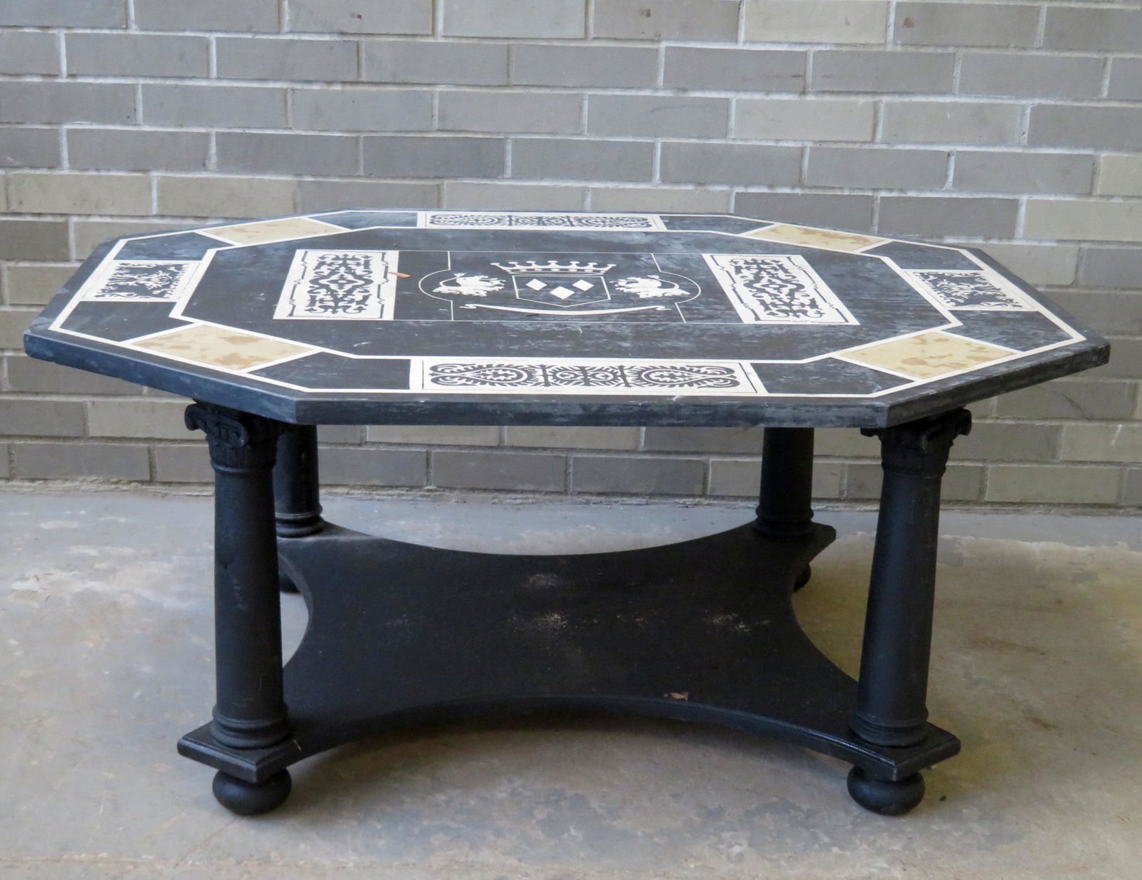 Arts & Crafts English style slate top coffee table. The: Arts & Crafts English style slate top coffee table. The top hand painted with a central medallion of a heraldry symbol (crown above 2 lions) - other hand painted decorations including geometric and sc