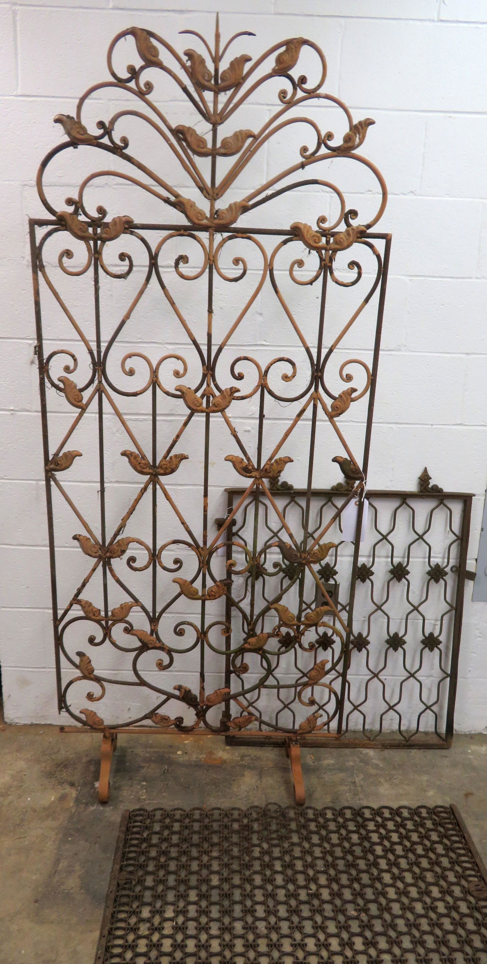 Three vintage metal garden or household ornaments: Three vintage metal garden or household ornaments including: A cast iron gate, with flowers attached to the iron strips on the front, late 19th century - some losses to the cast iron decorations on th