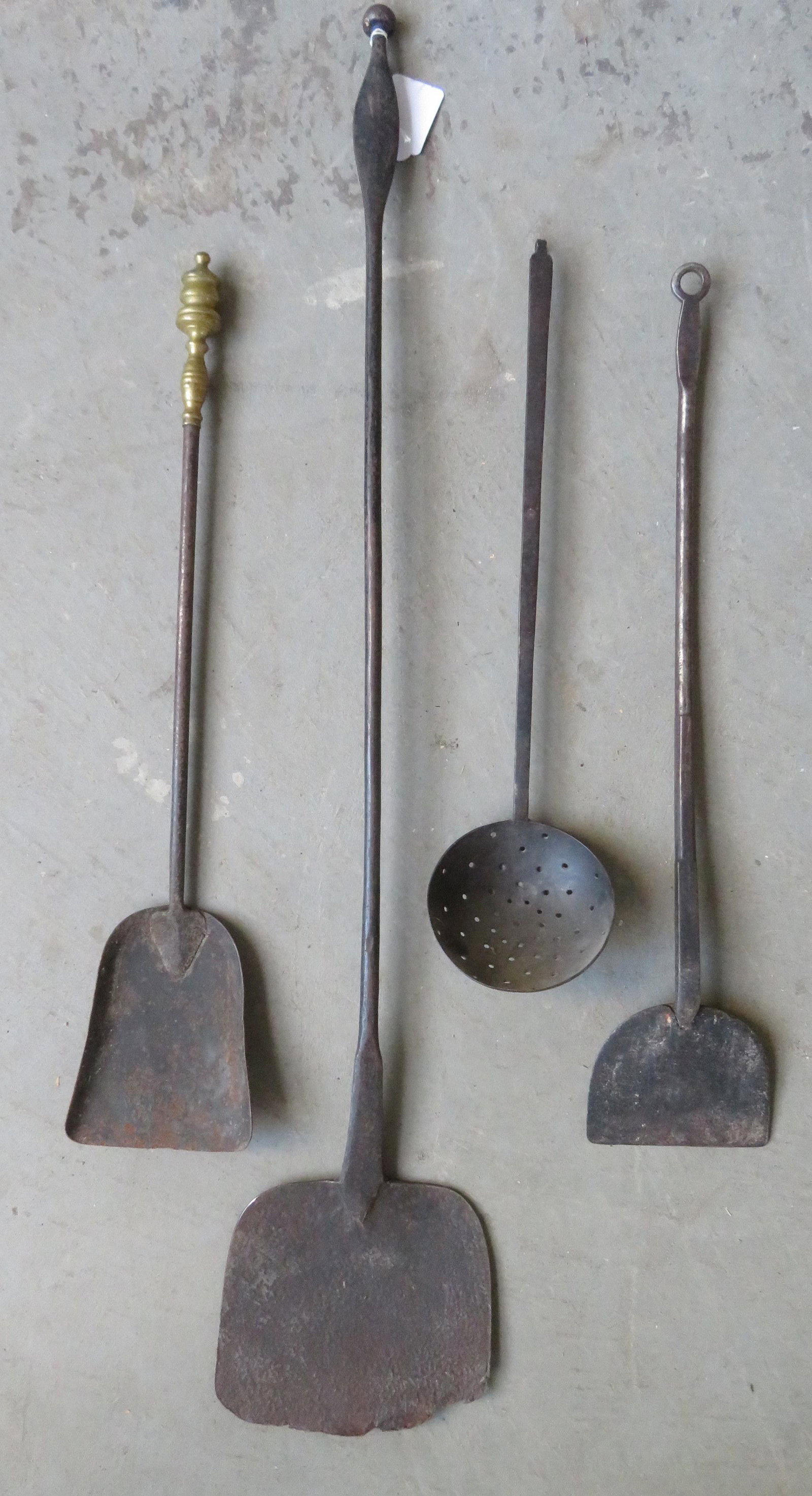 Grouping of mostly 4 early iron hearth items including:: Grouping of mostly 4 early iron hearth items including: 2 peels, 1 shovel, and 1 skimmer. All in good condition. Early 19th century.