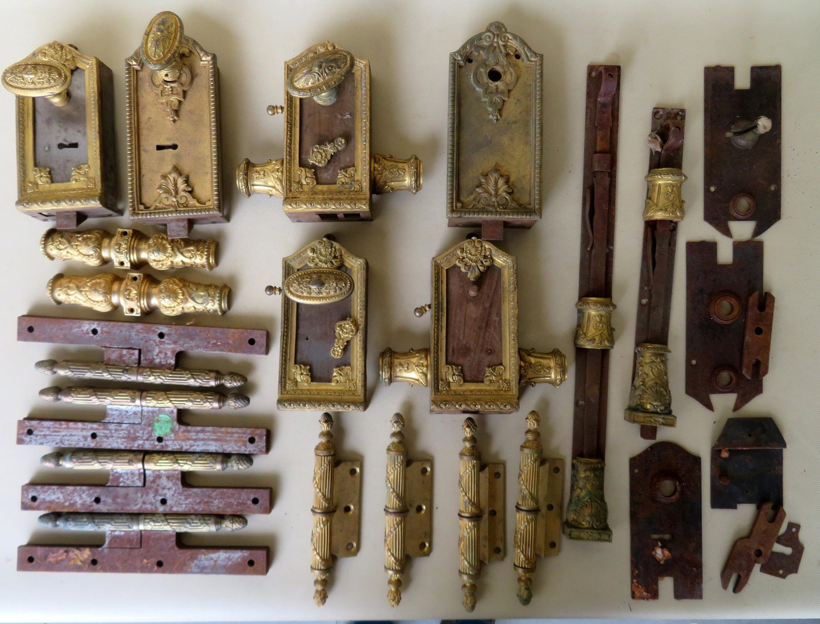 Large lot of brass/bronze French latches, locks and: Large lot of brass/bronze French latches, locks and hinges, late 19th century. See photos for further information. Some with losses, but overall good condition. Note Sotheby's label attached to one pi