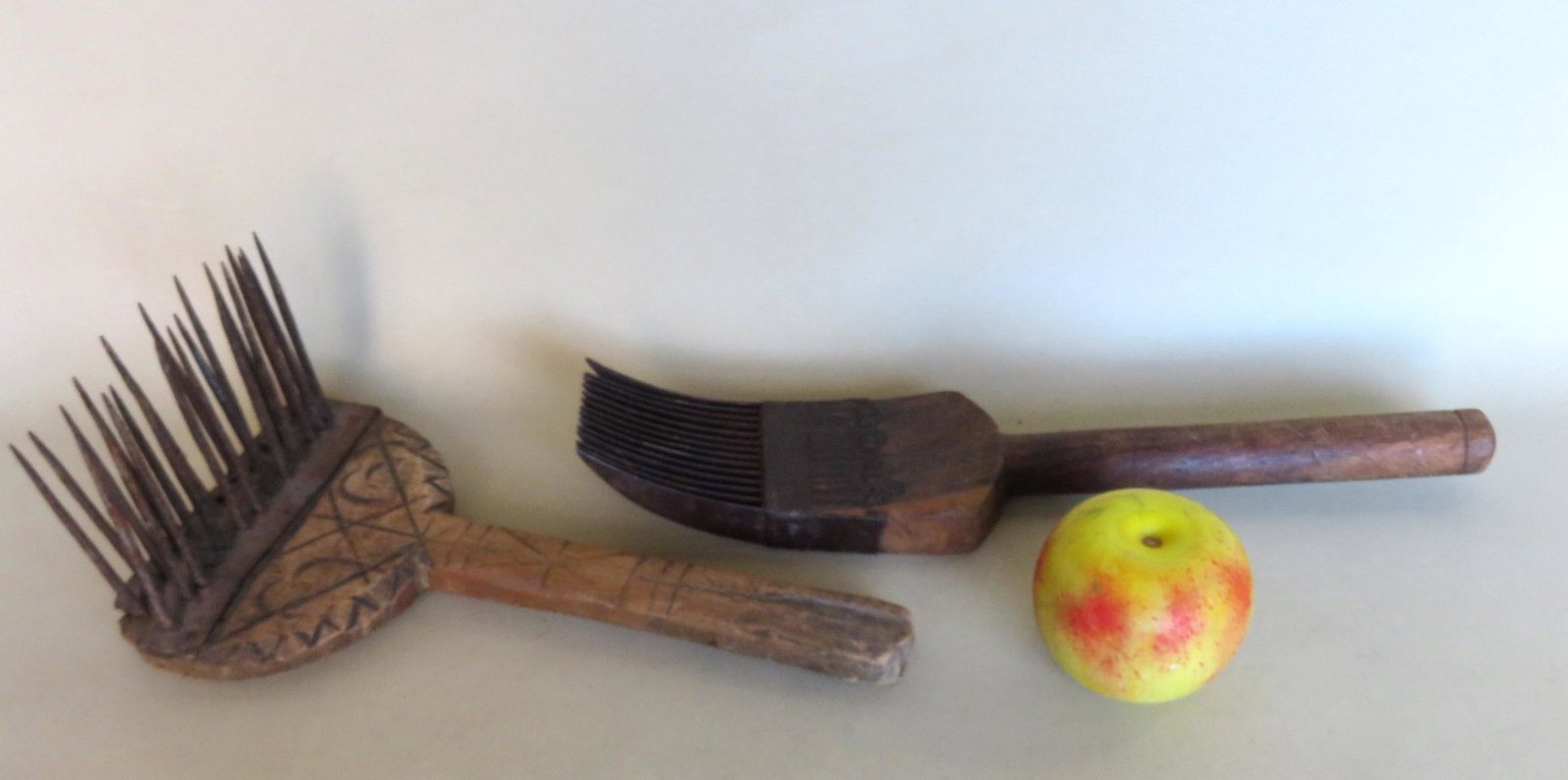 Two 18th century hand tools including a flax comb with: Two 18th century hand tools including a flax comb with carved wooden handle - 11 1/2"L x 6"W x 4 3/"H - 3 teeth missing otherwise very good condition, and an unknown combing tool with sheet iron finge