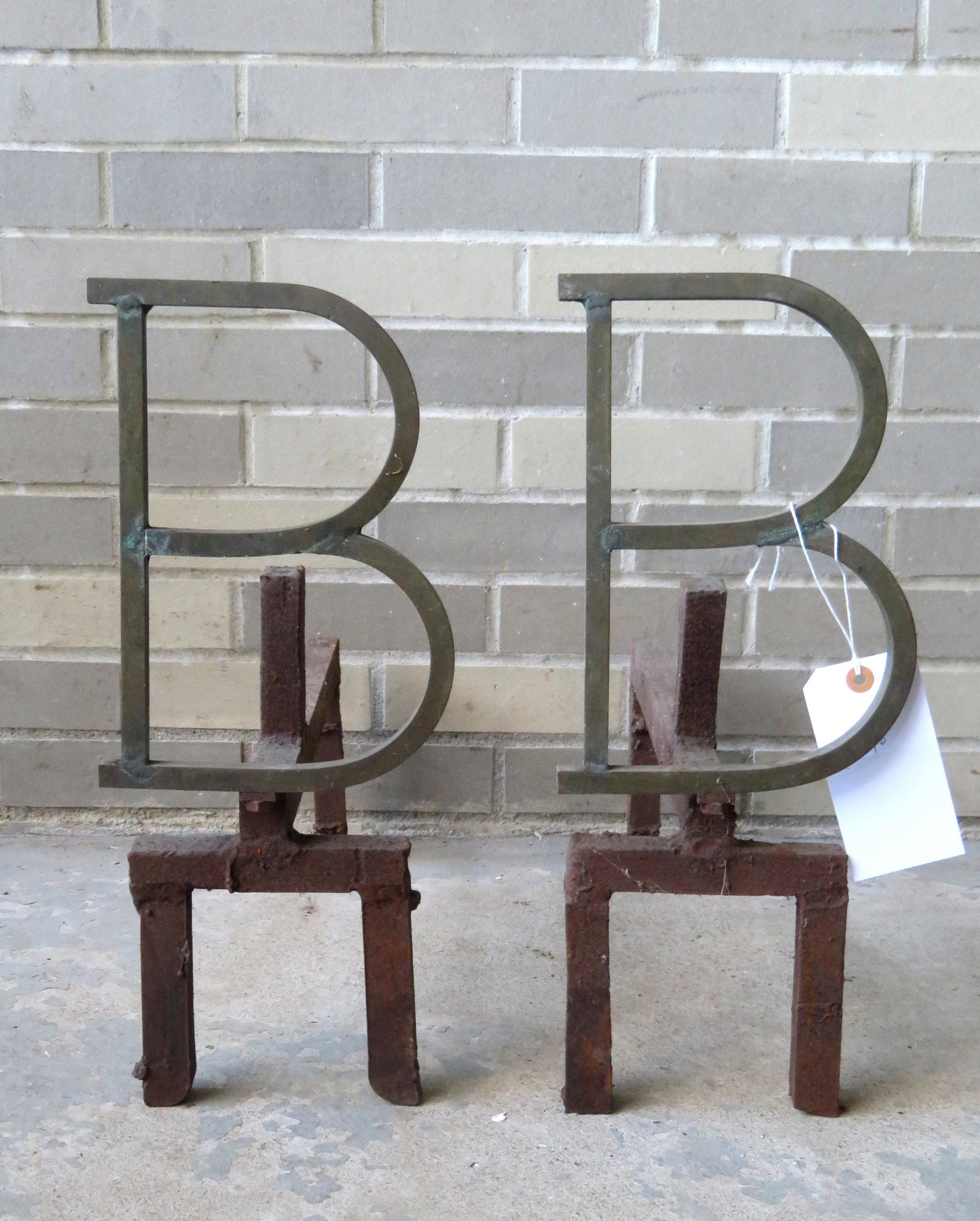 Pair of custom made brass and iron "B" form andirons,: Pair of custom made brass and iron "B" form andirons, mid 20th century. The letter "B" in brass (or bronze), and the firedogs in cast iron. 18"H x 20"D. Very good condition.