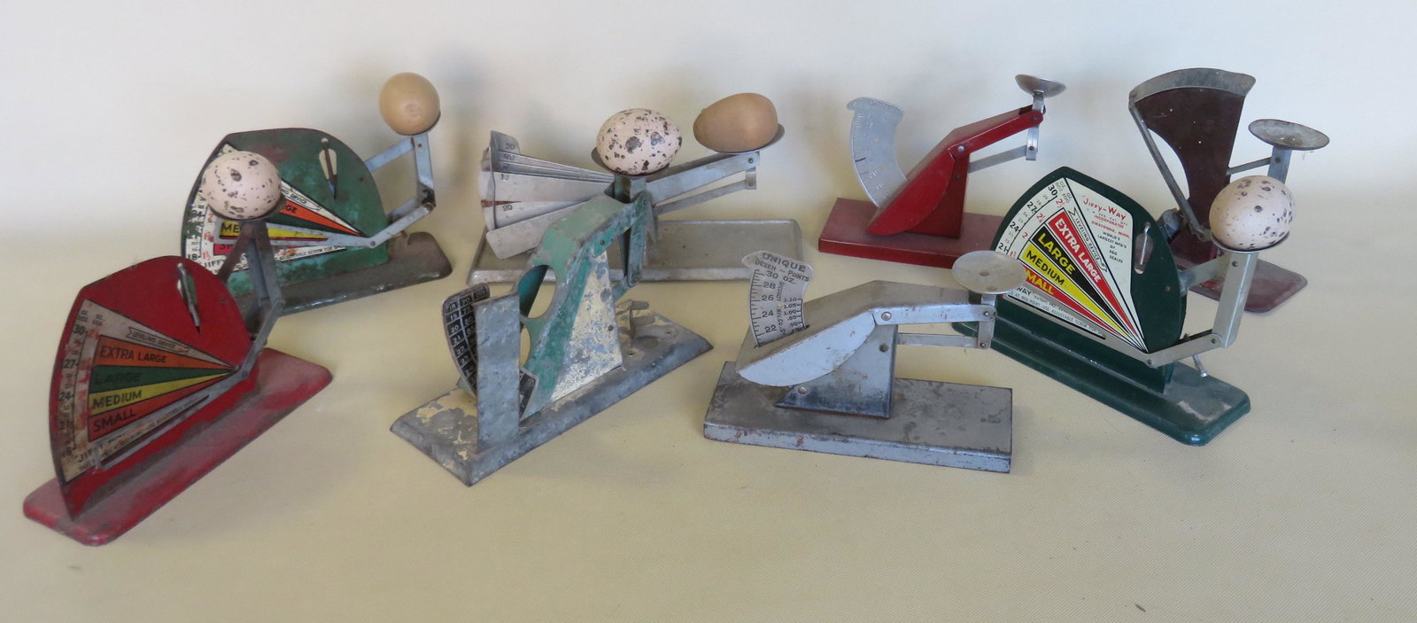 Grouping of 8 tin and aluminum egg scales including 3: Grouping of 8 tin and aluminum egg scales including 3 signed "Jiffy-Way", 1 signed "Specialty Mfg. Co. St. Paul Minn. USA", 1 signed "Acme Egg Grading Scale", and 3 not signed. All with some use wear,