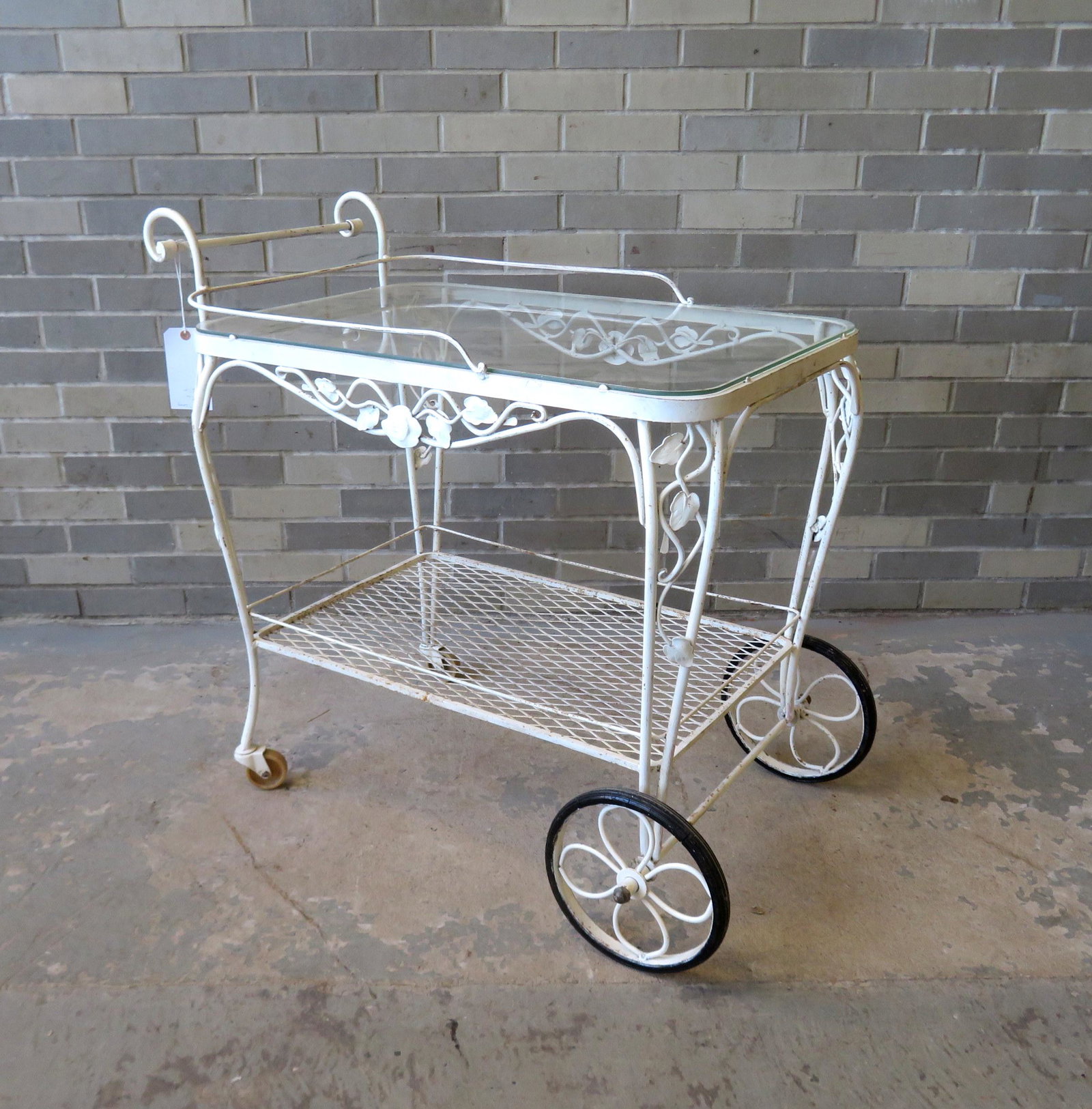 Wrought iron tea cart with glass top, very good: Wrought iron tea cart with glass top, very good condition - 41"L x 21"W x 33"H. Circa 1950.
