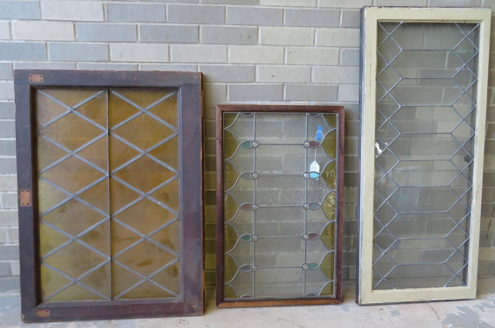 Grouping of 3 leaded glass windows, one with stained: Grouping of 3 leaded glass windows, one with stained glass, all in geometric patterns, and all in good condition. The largest 19 1/4" x 43 1/2", middle size 25 1/2" x 34 3/4" and the smallest 19" x 30