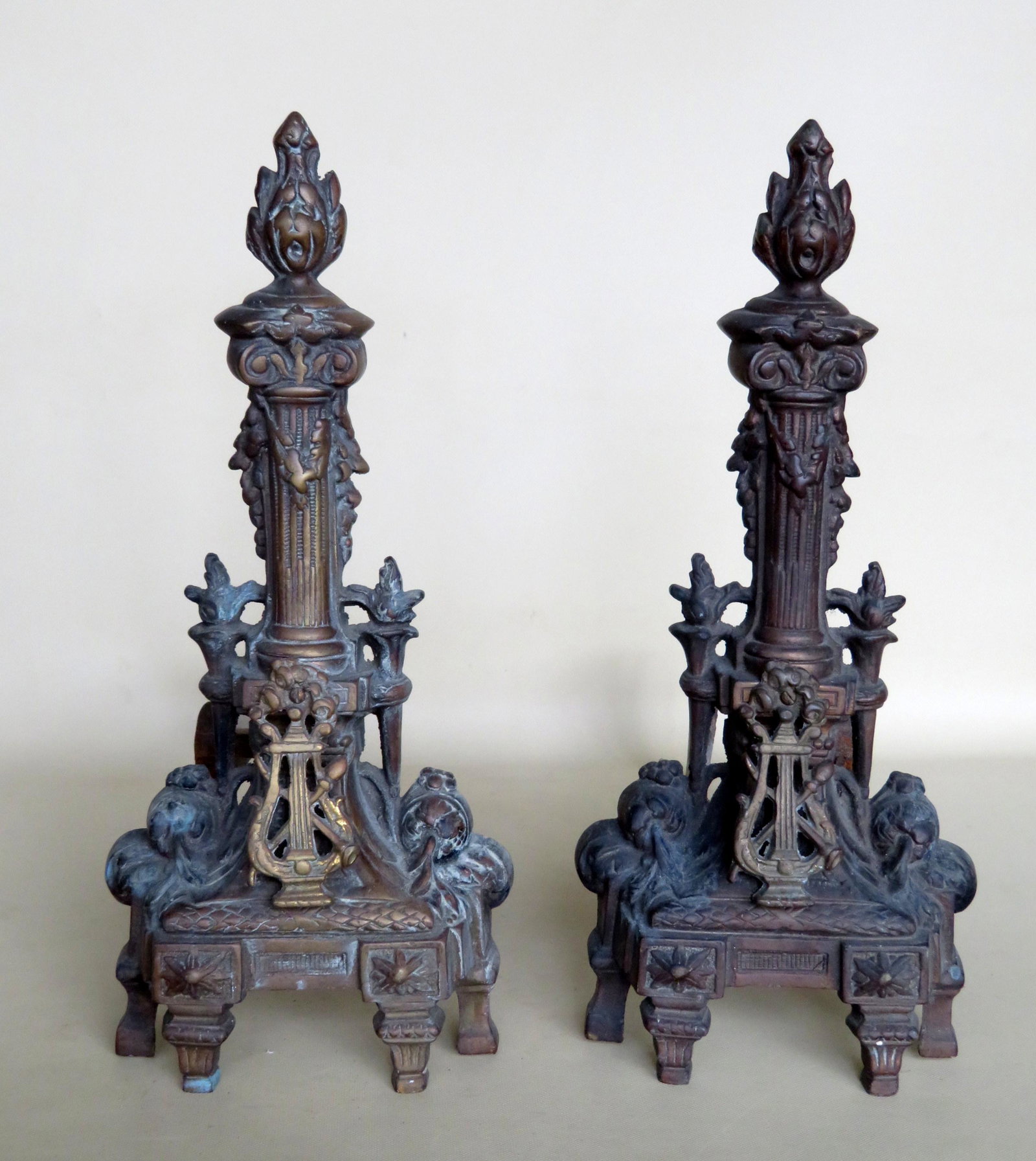 Pair of bronze French andirons, circa 1900, with flame: Pair of bronze French andirons, circa 1900, with flame finials. 17 1/2"H x 19"D. Very good condition.