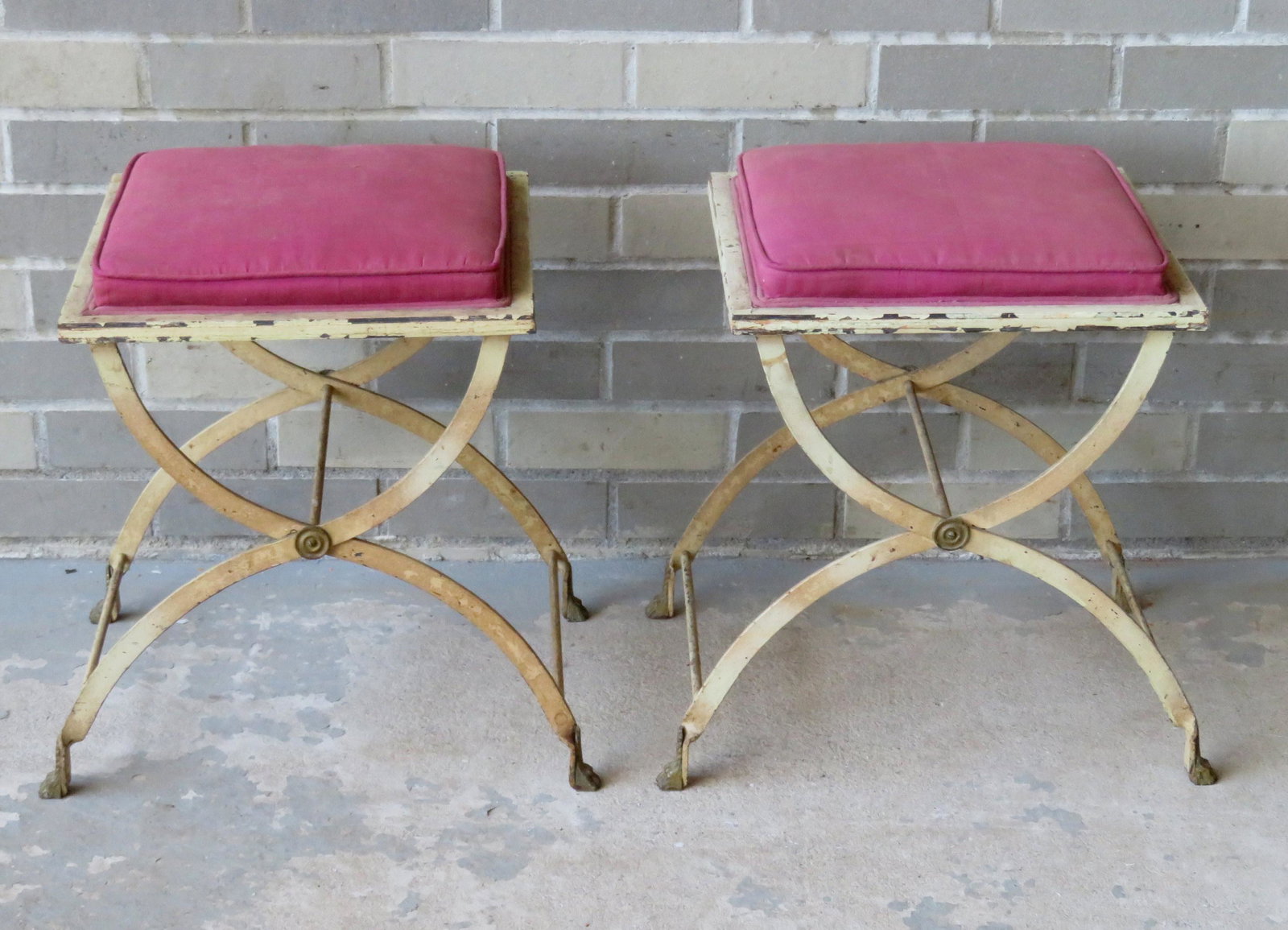 Two mid-century iron stools in regency style having: Two mid-century iron stools in regency style having brass claw feet and upholstered seat attached to painted wood frame. Signed on reverse "Sold by W & J Sloane 575 Fifth Avenue New York, NY". 13 1/2"