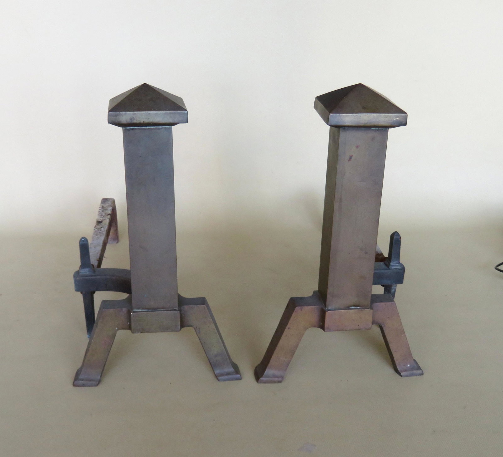 A pair of Arts & Crafts mission style brass andirons.: A pair of Arts & Crafts mission style brass andirons. One dog repaired, small chip on edge, else very good condition. 13 1/2"H x 18"D x 8"W.