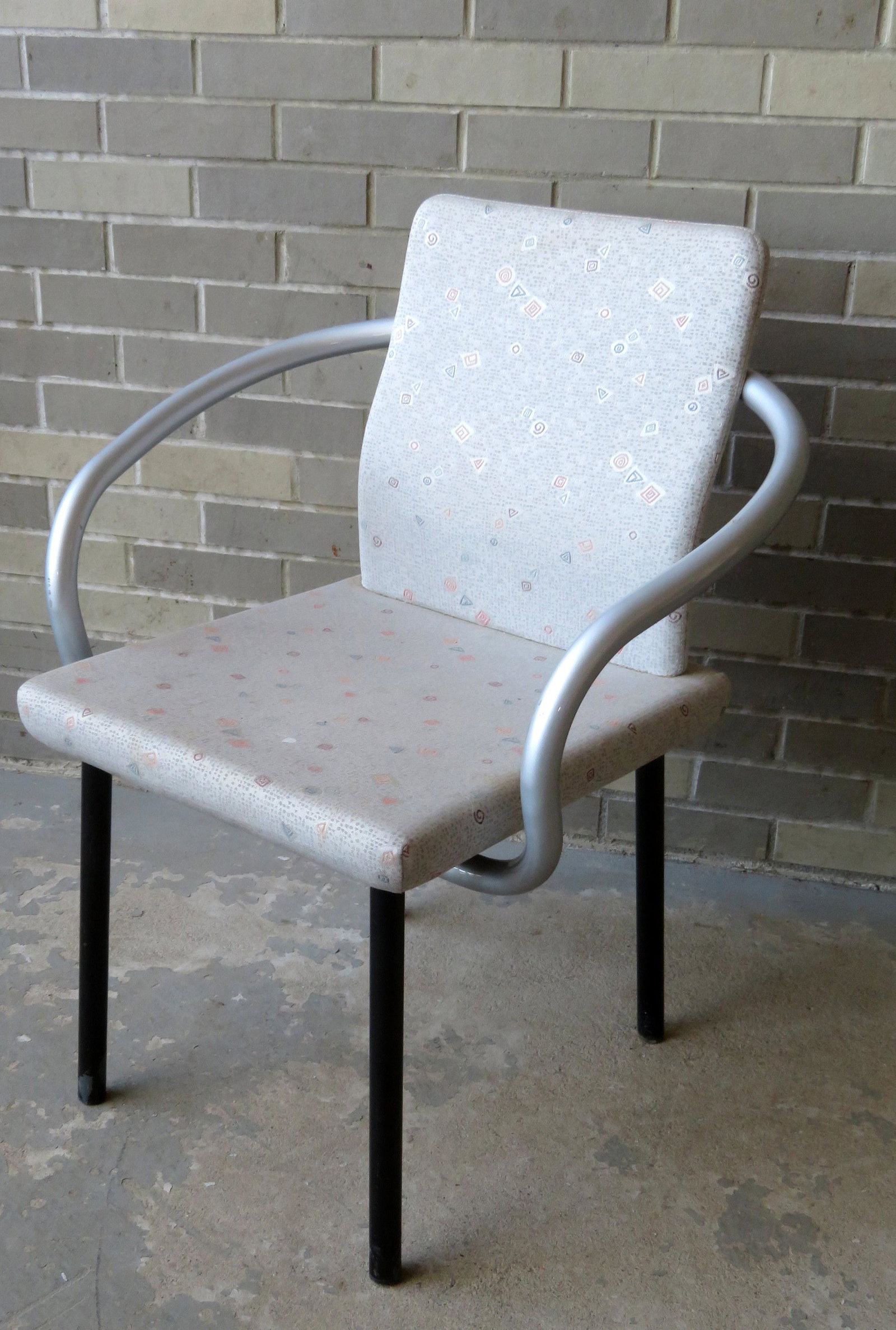 Knolls arm chair designed by Ettore Sottsass. Some: Knolls arm chair designed by Ettore Sottsass. Some scratches and wear to the rear section of the metal arms, but overall very good condition. 33"H x 25 1/2"W x 22"D.