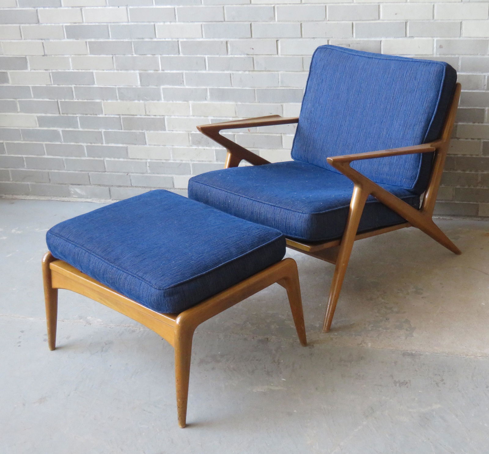 Poul Jensen, Danish designer. Z-chair plus ottoman,: Poul Jensen, Danish designer. Z-chair plus ottoman, both with inset painted tin label marked "Made and Finished in Denmark / Imported by Selig". Blue corduroy upholstery in good condition. Chair size