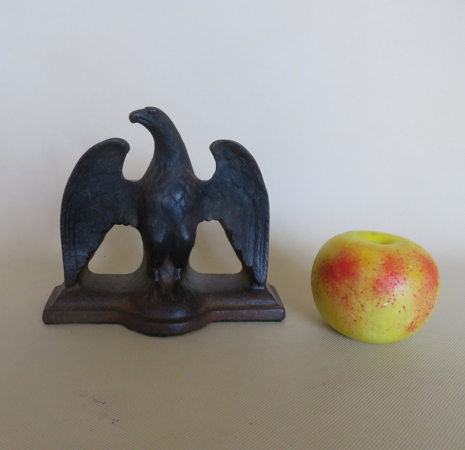 A cast iron spread wing eagle door stop. Appears to: A cast iron spread wing eagle door stop. Appears to retain original black paint. Very good condition. 6 1/2"W x 5 3/4"H.