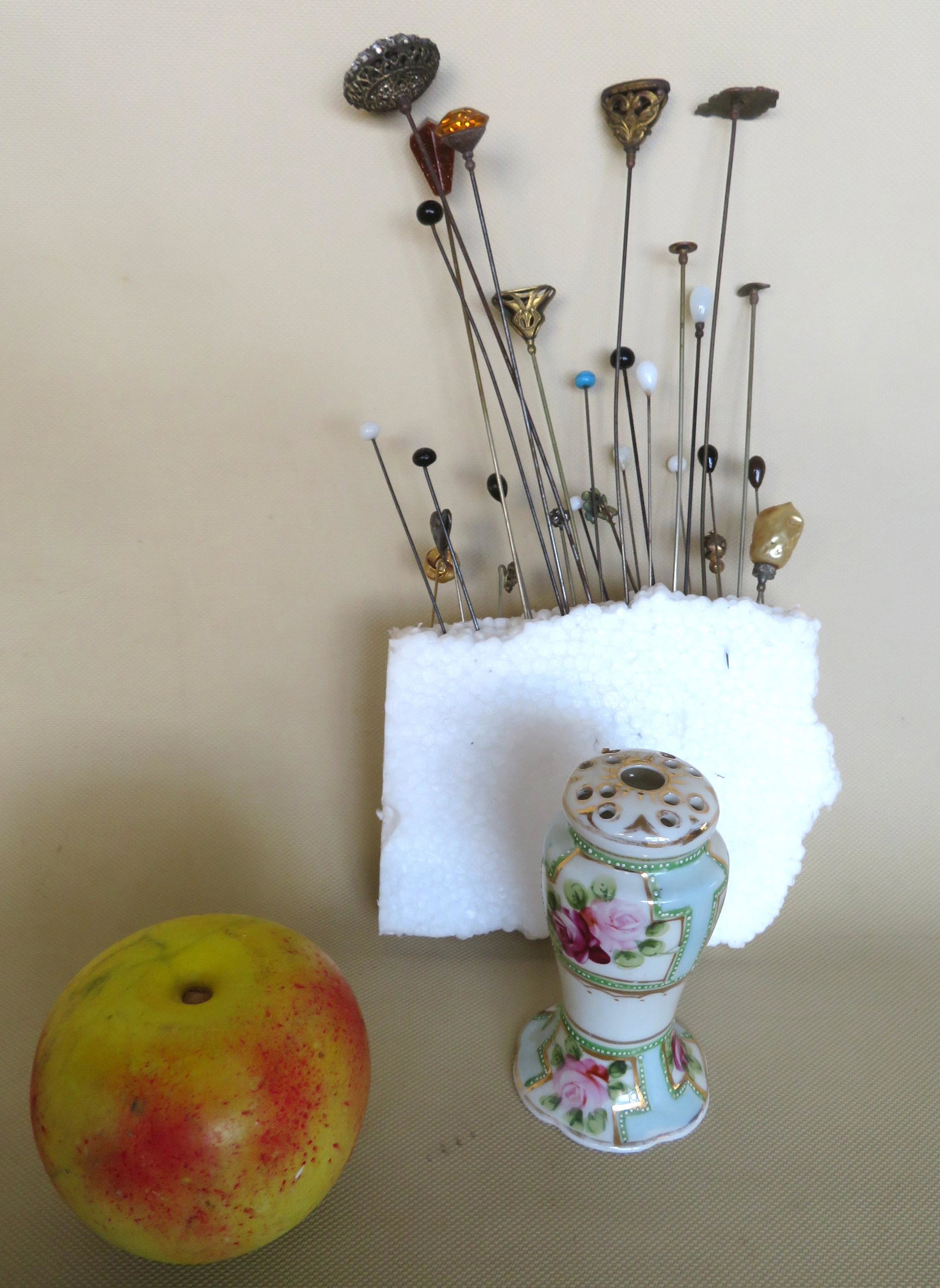 Grouping of vintage hat pins and a Nippon porcelain hat: Grouping of vintage hat pins and a Nippon porcelain hat pin holder. Late 19th to early 20th century. See photos for details.