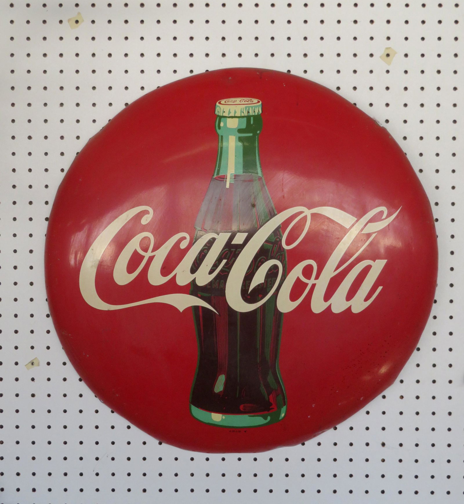 Vintage Coca Cola button sign featuring the Coca Cola: Vintage Coca Cola button sign featuring the Coca Cola bottle, marked "A-M 5-56" (1956) - 24"D. Very good condition.
