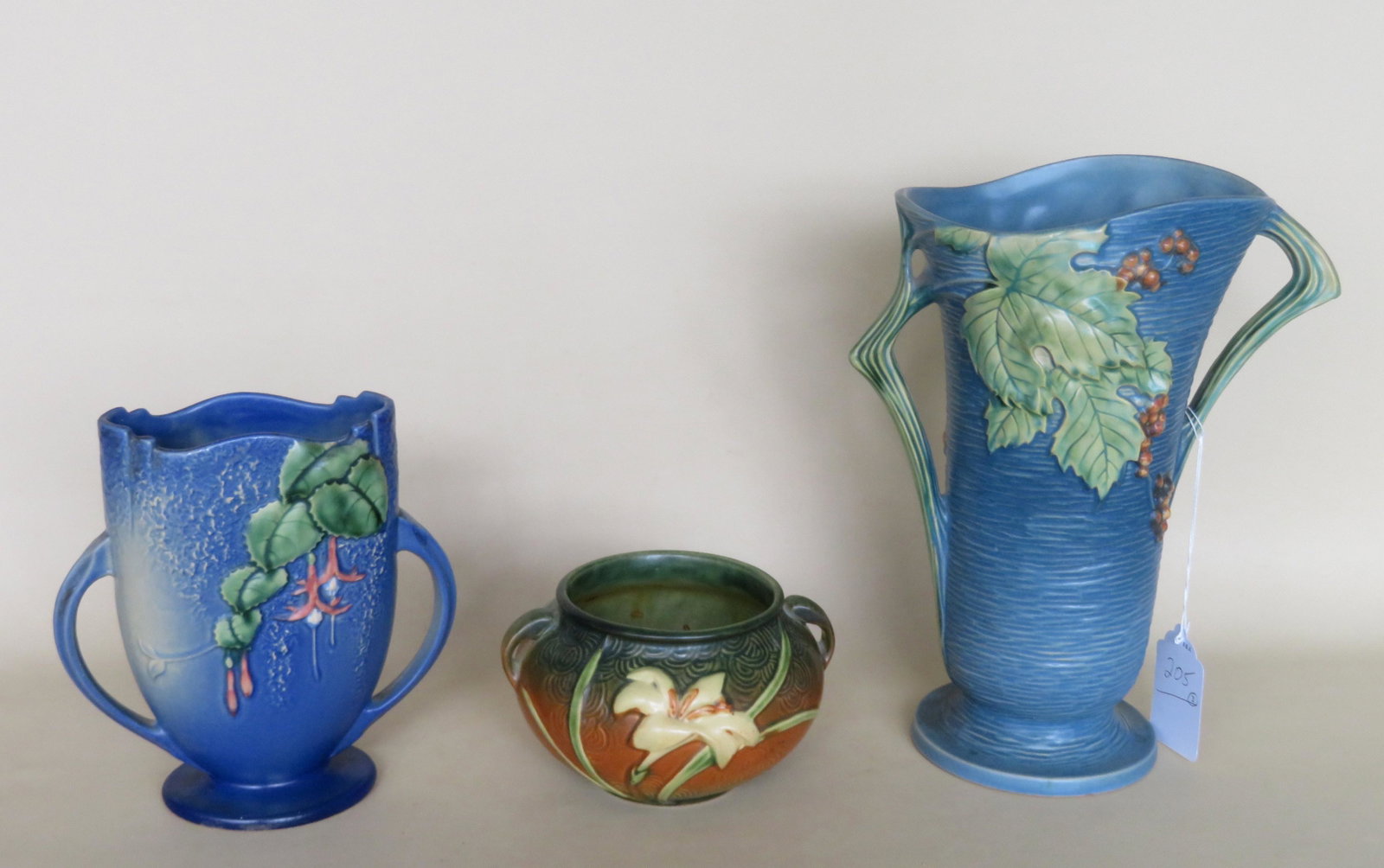 Three Roseville art pottery vases including double in: Three Roseville art pottery vases including double in Bushberry pattern marked 38-12" - small chip on bottom edge, double handle vase Fuchsia pillow vase marked 896-8" - no damage, very good condition