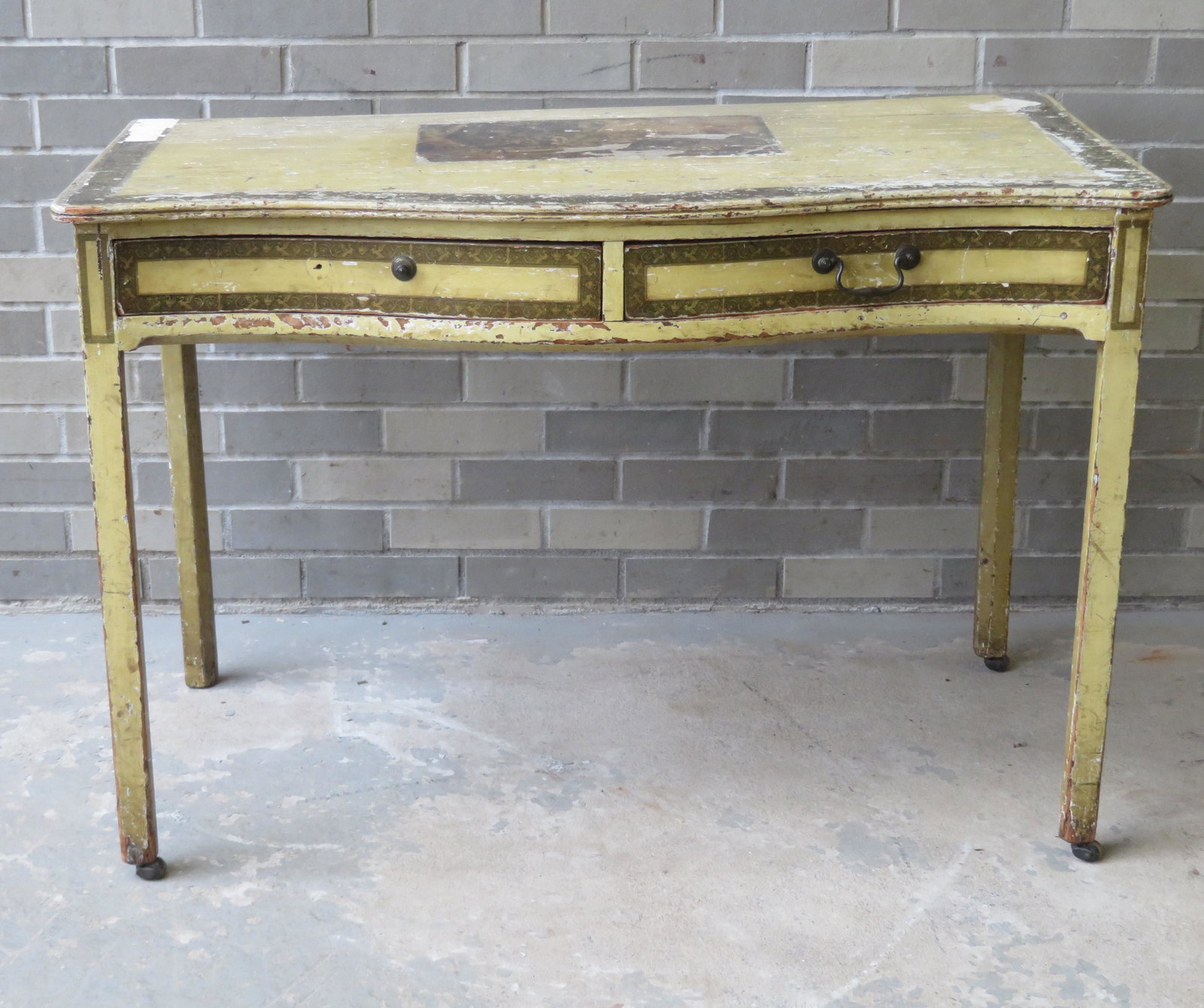 Chippendale work table with serpentine front having 2: Chippendale work table with serpentine front having 2 drawers with bale pulls (1 pull missing) and square legs with chamfering on back edge - casters on legs. Condition: It has a small split in the wo