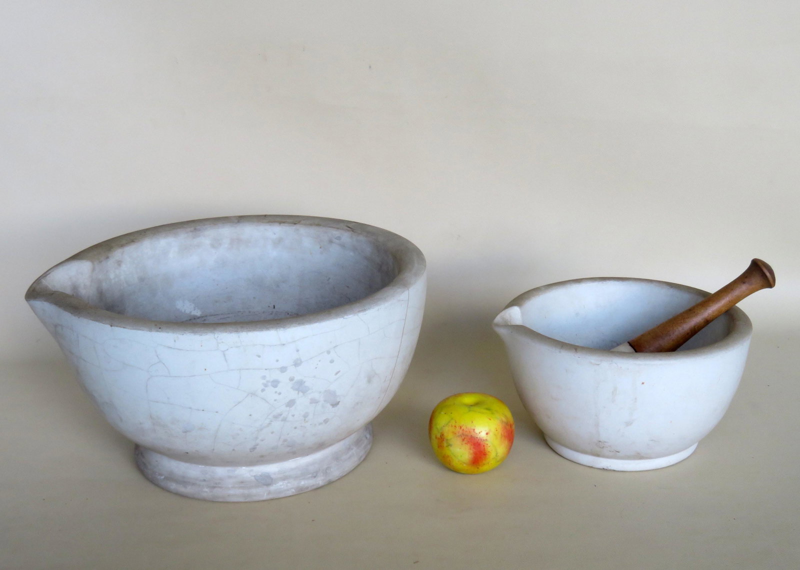 Two white stone mortar and pestles. The smallest mortar: Two white stone mortar and pestles. The smallest mortar 9 3/4"D x 5"H and pestle 9"L are in good condition; and the largest mortar (repaired - see photos) measures 14 1/2"W x 7 1/2"H - the pestle - xx