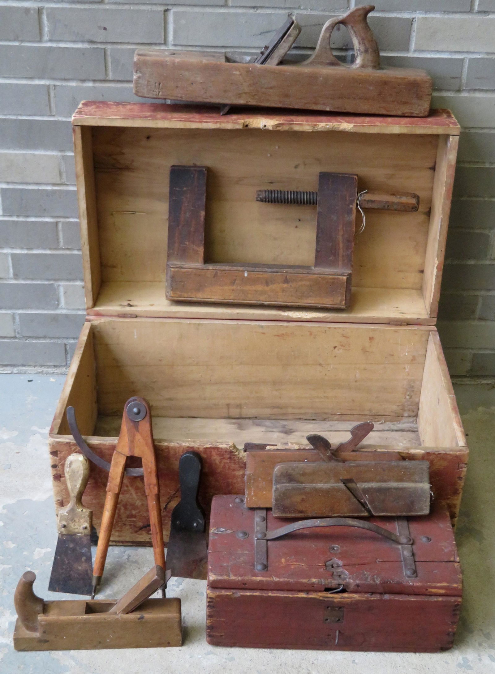 A grouping of 2 primitive boxes and 9 vintage tools: A grouping of 2 primitive boxes and 9 vintage tools including wooden caliper, several block planes, a wooden vise, a small wooden box with fitted interior and dovetailed construction, a larger wooden
