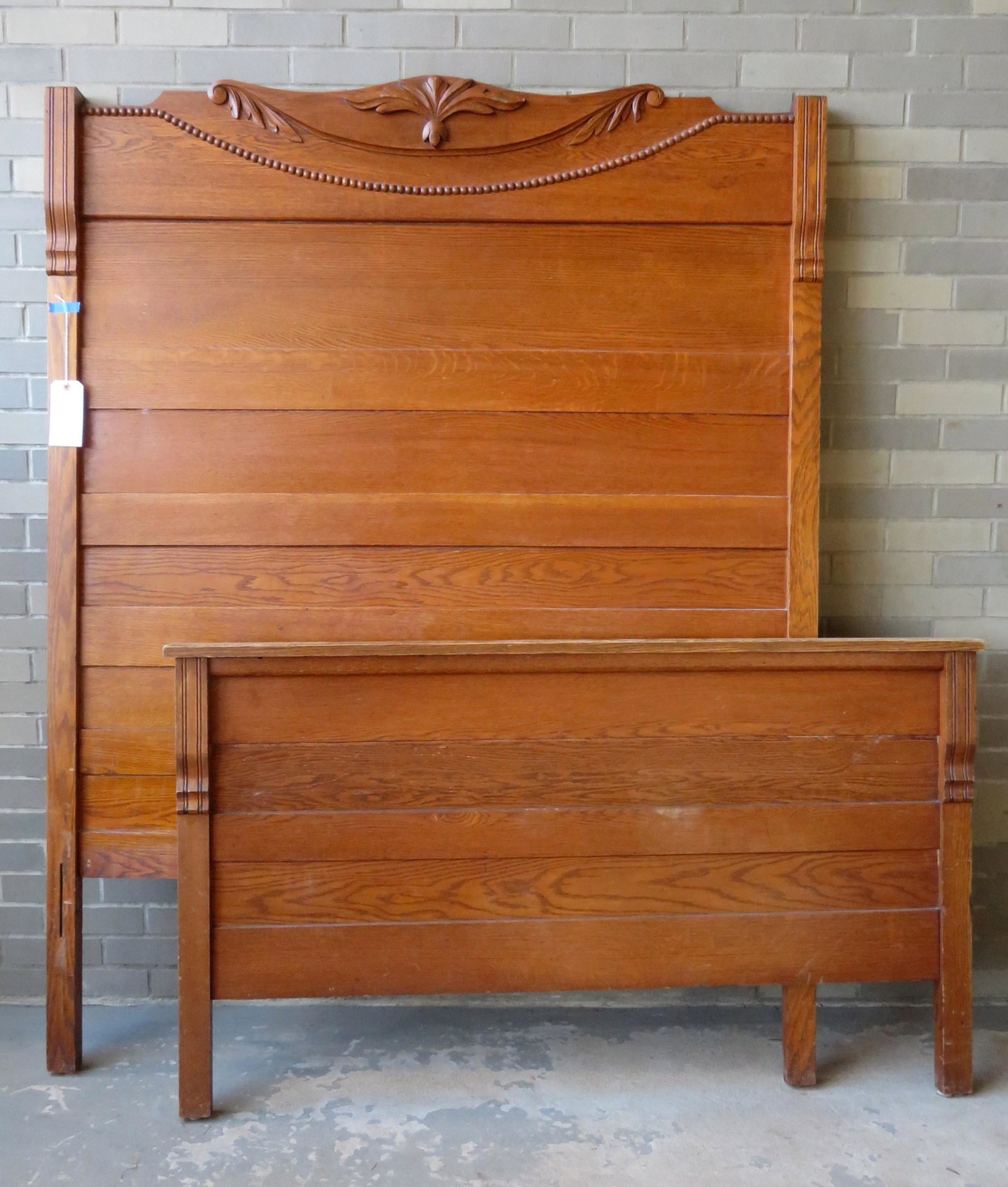 Golden oak bedstead with applied molding on crest. Very: Golden oak bedstead with applied molding on crest. Very good condition, early 20th century, 56 1/2"W x 74"H x 72" L (bed rails).