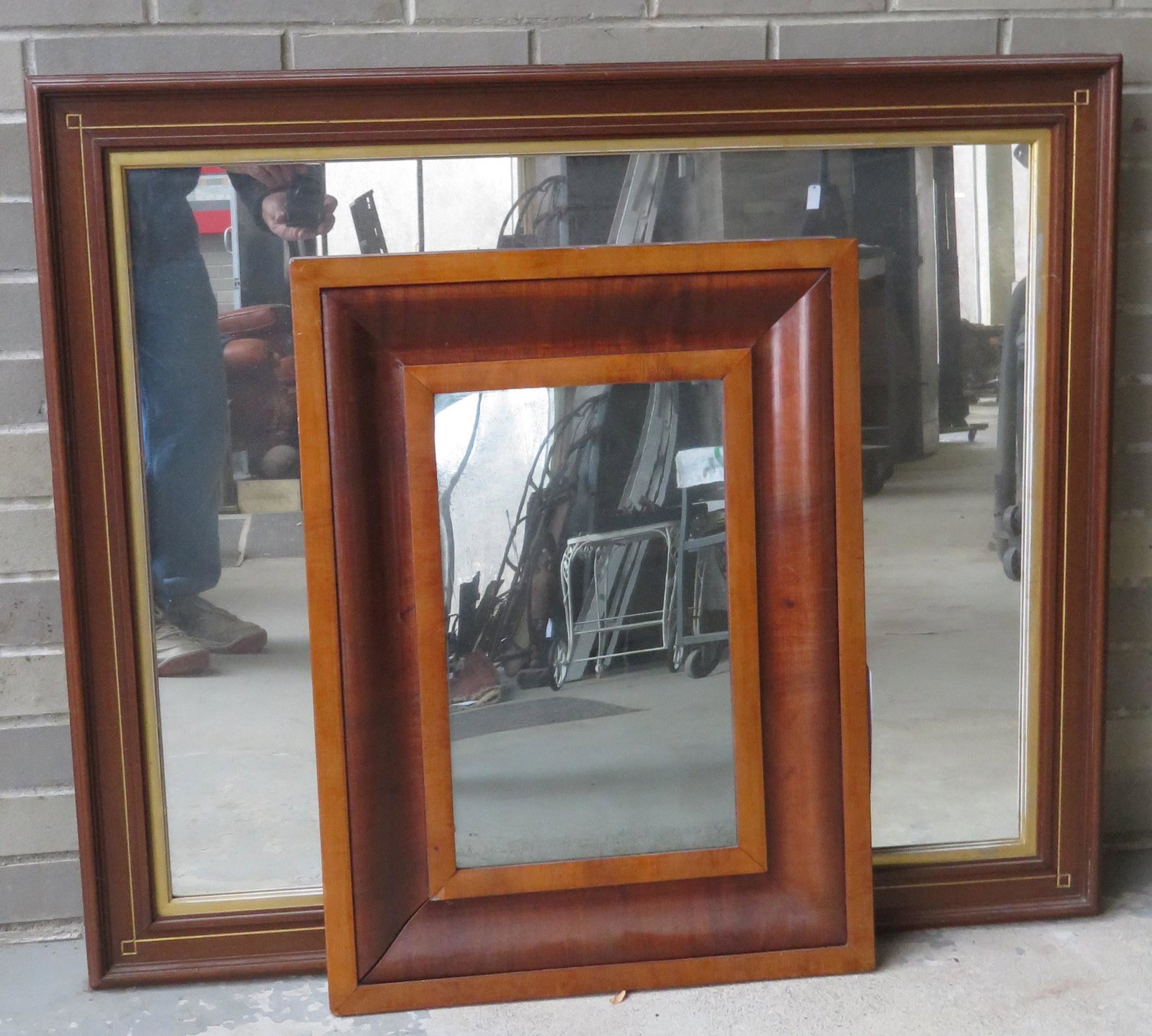 Two early mirrors including: An Empire period ogee: Two early mirrors including: An Empire period ogee mahogany mirror, refinished in very good condition - 19" x 25 1/2"; and a Victorian black walnut mirror in very good condition - 37" x 31".