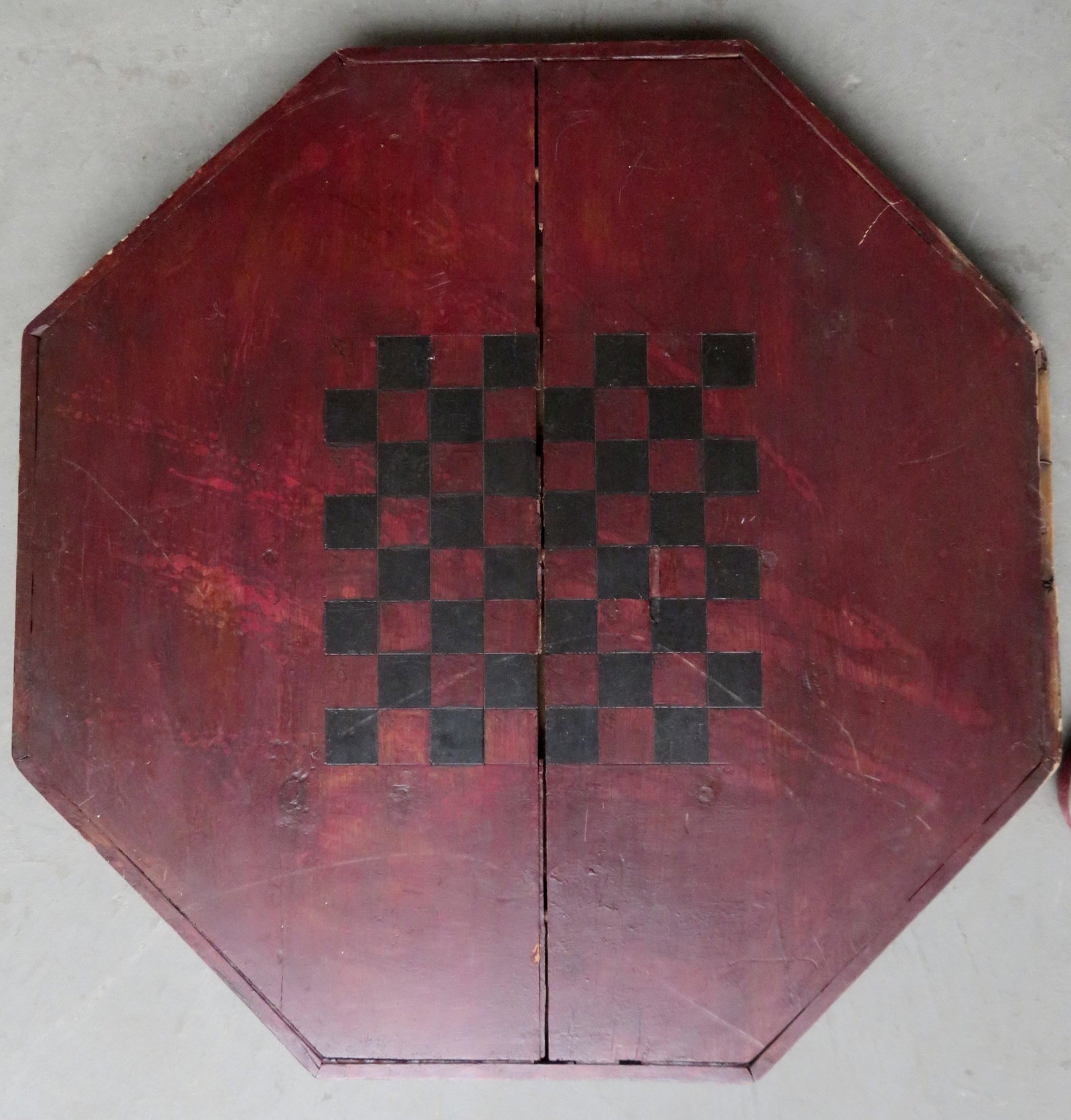 Vintage barrel top octagonal shaped game board in: Vintage barrel top octagonal shaped game board in original red and black paint, late 19th century. 29"D.