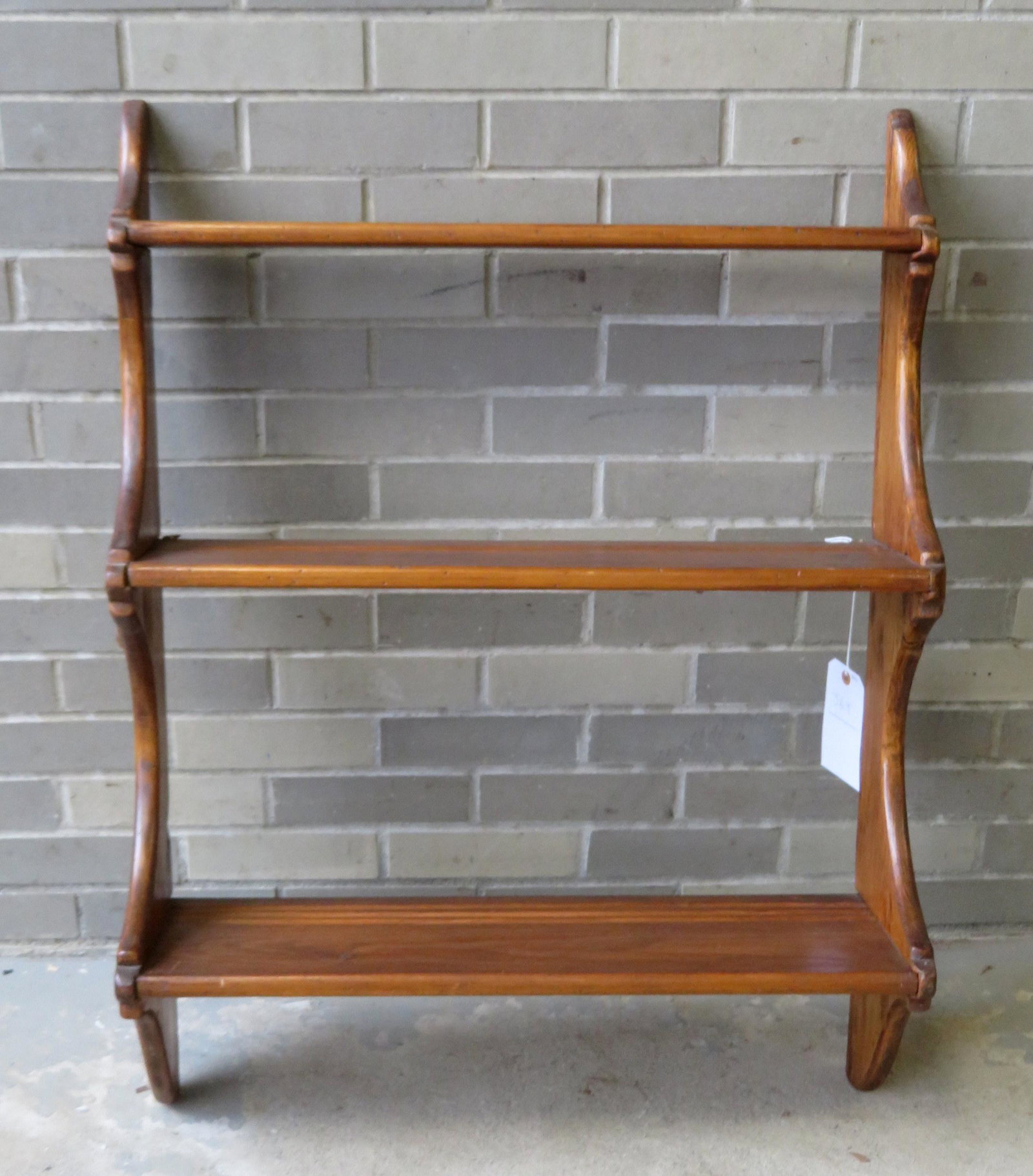 Early pine 3 tier graduated wall shelf, 19th century,: Early pine 3 tier graduated wall shelf, 19th century, with plate grooves, 27 1/4"W x 4 1/4"D (top shelf) x 8 1/2"D (bottom shelf) x 36"H. Small chip on back edge of top shelf, else good condition.