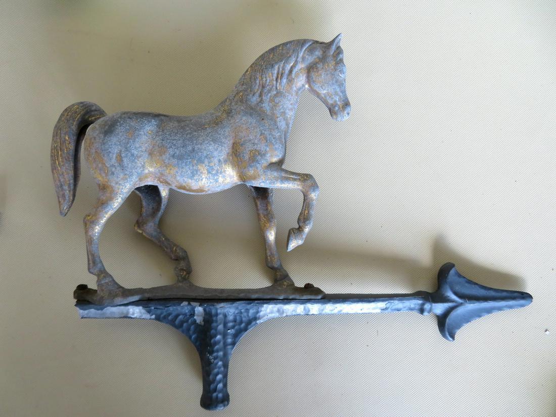 An aluminum full body horse weathervane with traces of: An aluminum full body horse weathervane with traces of original gilt, with directionals. Directional arrow is broken and the mounting steel pin is bent, The vane itself is in very good condition. Circ
