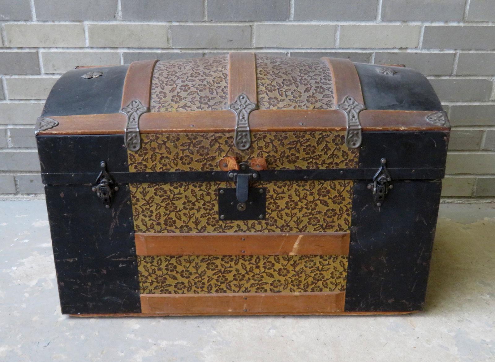 Vintage dome top metal trunk with oak slats and metal: Vintage dome top metal trunk with oak slats and metal bands, having an interior lift top compartment - sold with 3 mounted shoe forms that have been converted to a coat rack see photos.