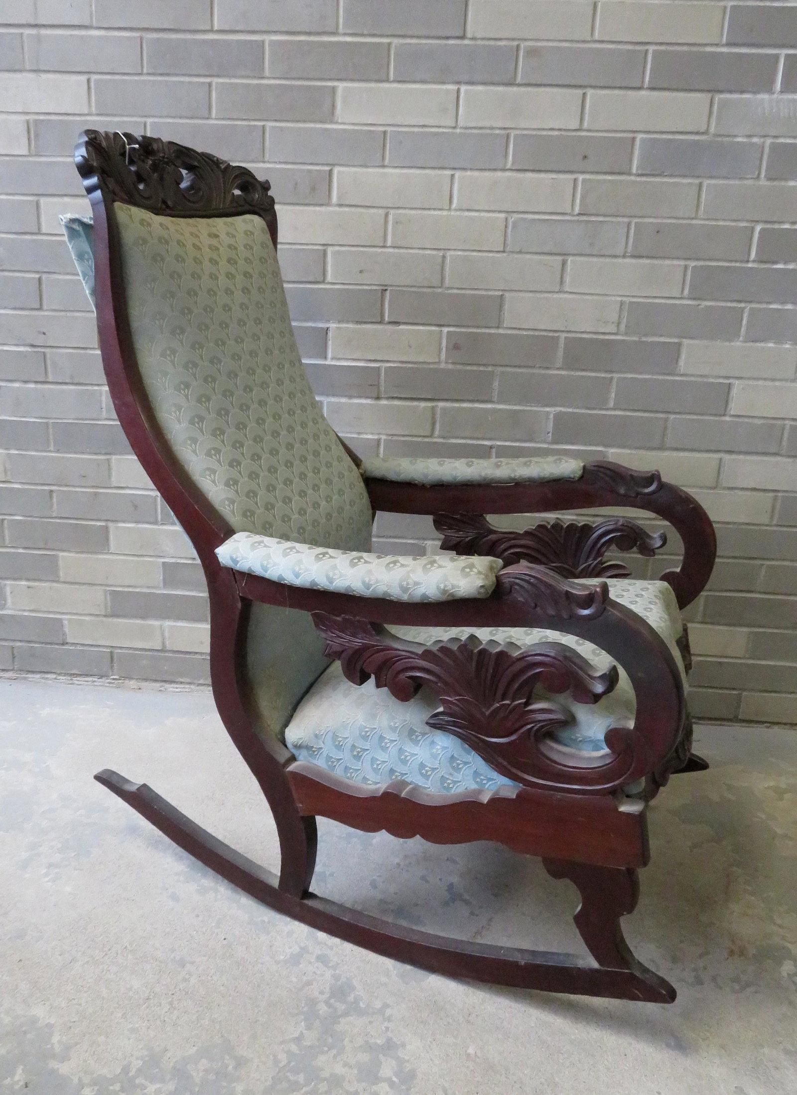 Victorian Lincoln rocker with upholstered and scrolled: Victorian Lincoln rocker with upholstered and scrolled arms, horn of plenty carved arm supports, rose carved and scrolled crest, serpentine front with rose and leave carving on front apron. Original f