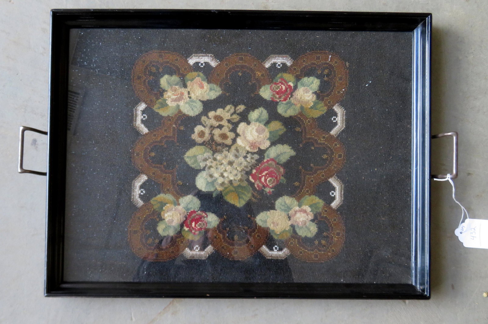 Serving tray with nickel plated handles each end, and: Serving tray with nickel plated handles each end, and having a wooden frame in original black lacquer encompassing a beautifully designed central image of a floral arrangement in beadwork and needlepo
