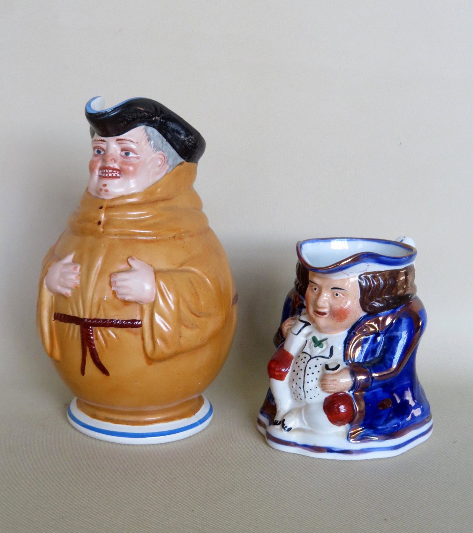 Two 19th century pitchers including: A French friar: Two 19th century pitchers including: A French friar pitcher marked "Creil Et Montereau" - 9"H - small interior rim chip, else good condition; a Staffordshire figural toby mug signed "Allertons - Made 