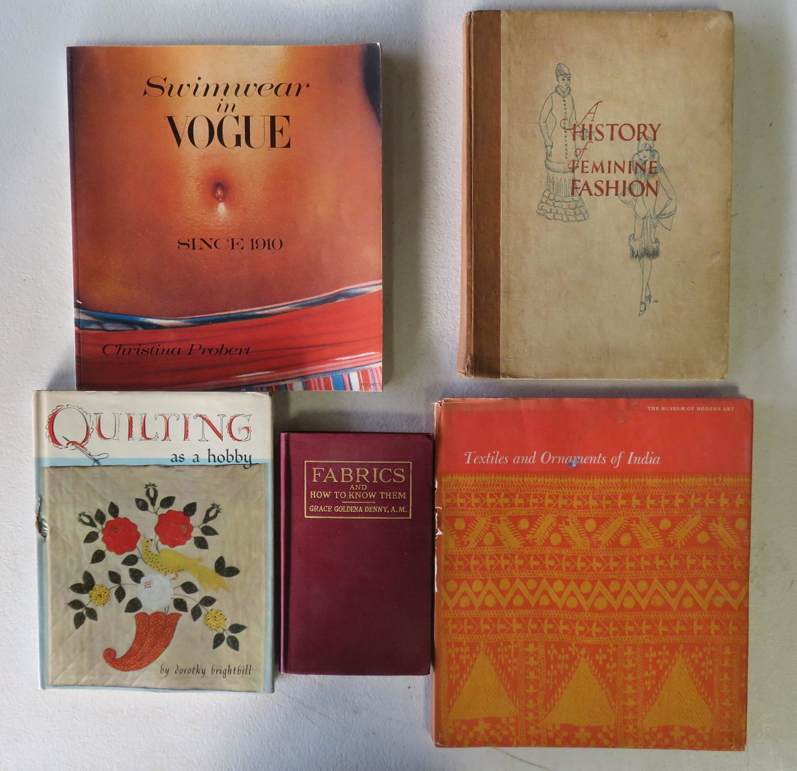 Grouping of textile related books including: A History: Grouping of textile related books including: A History of Feminine Fashion, publish in London by E.J. Burrow, circa 1915 - minor foxing, overall good condition; Fabrics An How To Know Them by Grace Go