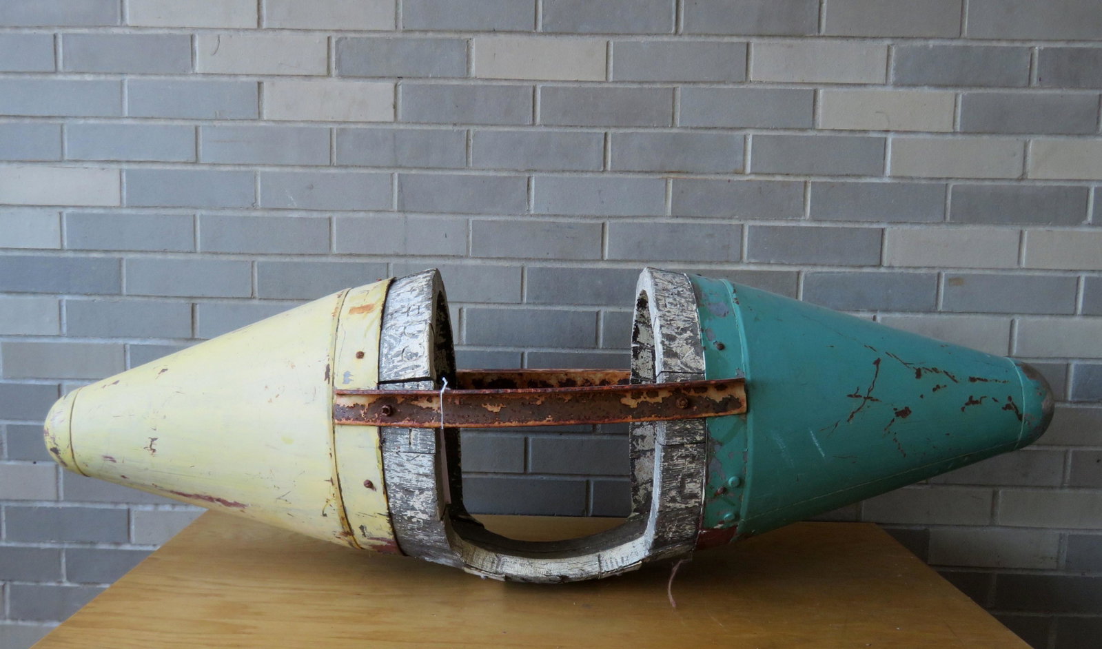 Rocket ship playground make-do riding toy, circa 1950,: Rocket ship playground make-do riding toy, circa 1950, several layers of old paint. The toy is constructed of 2 sheet metal cones on each end and an old staved barrel, cut to make the seating area - s