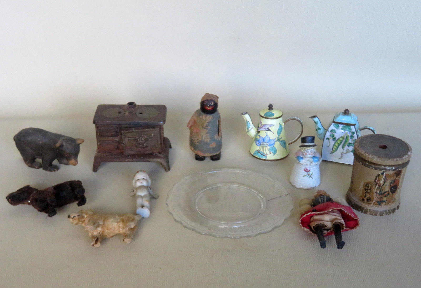 Grouping of miniature toys including: Pressed glass: Grouping of miniature toys including: Pressed glass centennial alphabet plate "Old Liberty Hall" - hairline on rim; souvenir composition black bear - good condition; cast iron and tin cook stove - lat